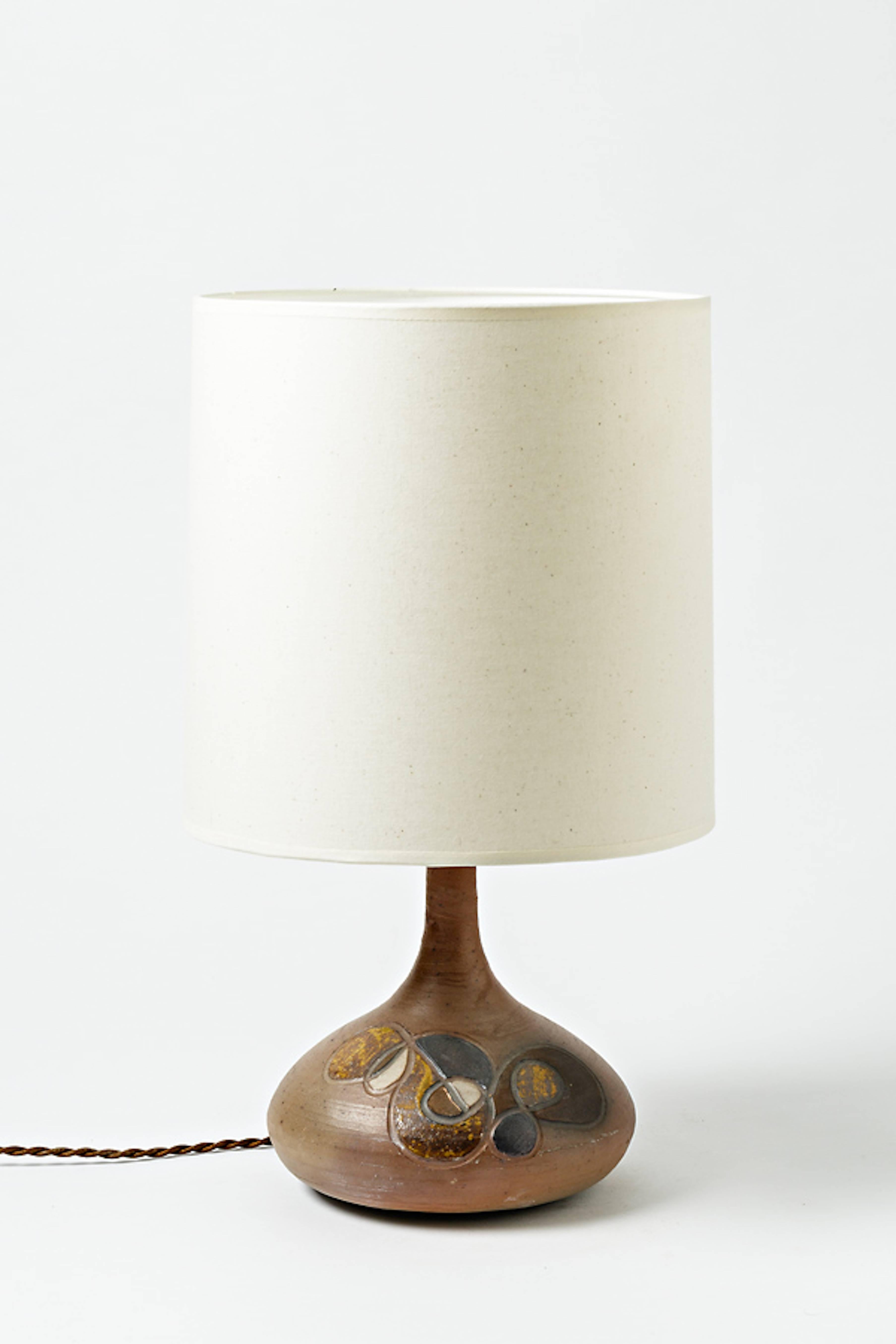 A small ceramic lamp with decoration.
Perfect original conditions,
circa 1970.
Sold with a new lampshade and a new electrical electrical system.

Height with lampshade: 17 ' inches. 
Diameter with lampshade: 9' 1/2 inches. 
Height without