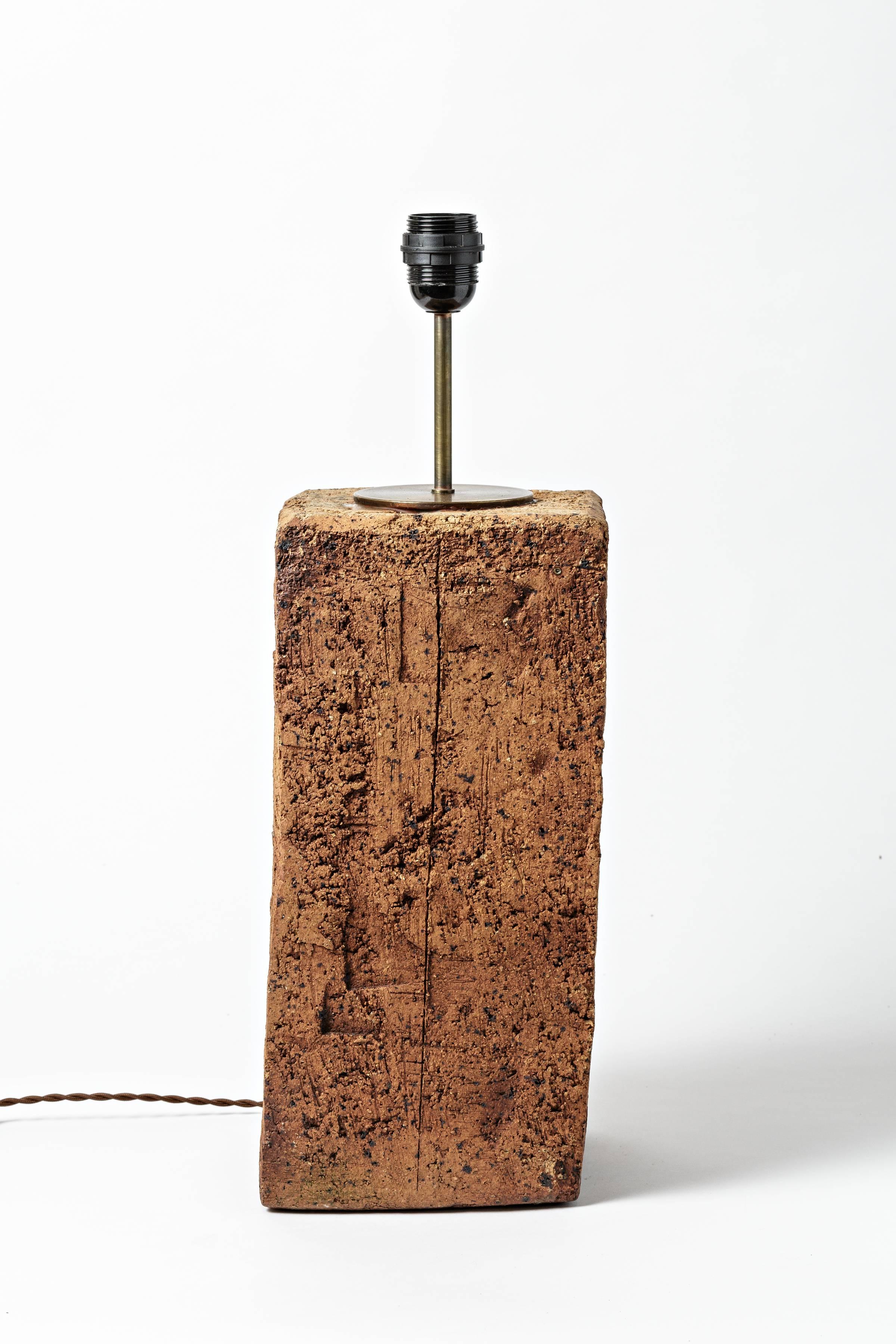 A Brutalist stoneware lamp by Gustave Tiffoche.
Unique piece,
circa 1970.
Sold with a new electrical system.

Dimensions with electrical system: 21' x 6' 1/ 2 x 6' 1/2 inch.

Dimensions without electrical system: 15' 1/3 x 6' 1/2 x 6' 1/2