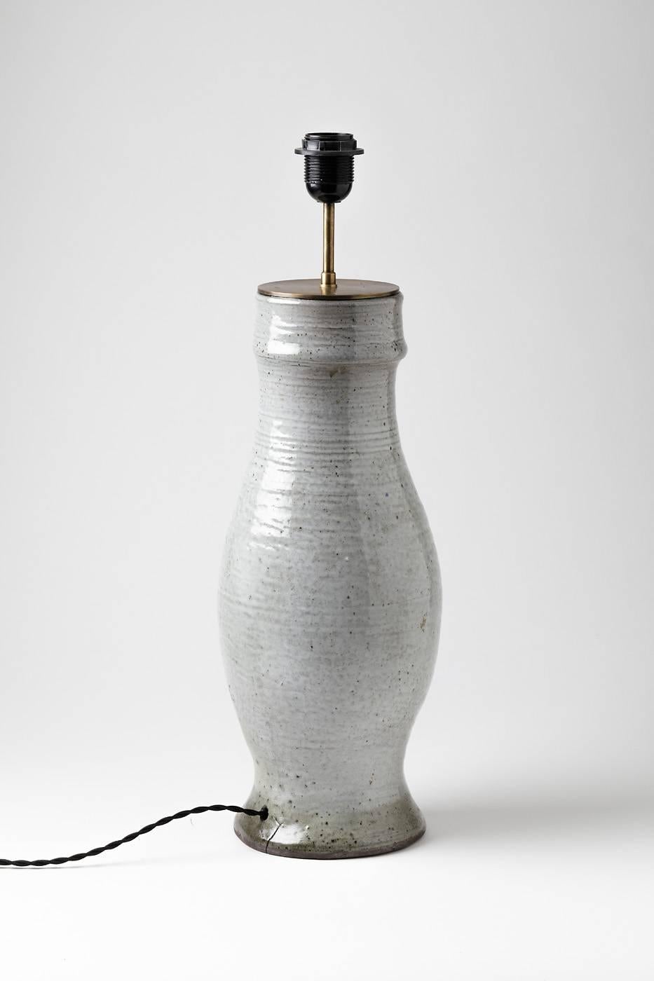 Elegant ceramic lamp by Norbert Pierlot, circa 1970.

Beautiful white ceramic glaze .

Signed under the base 