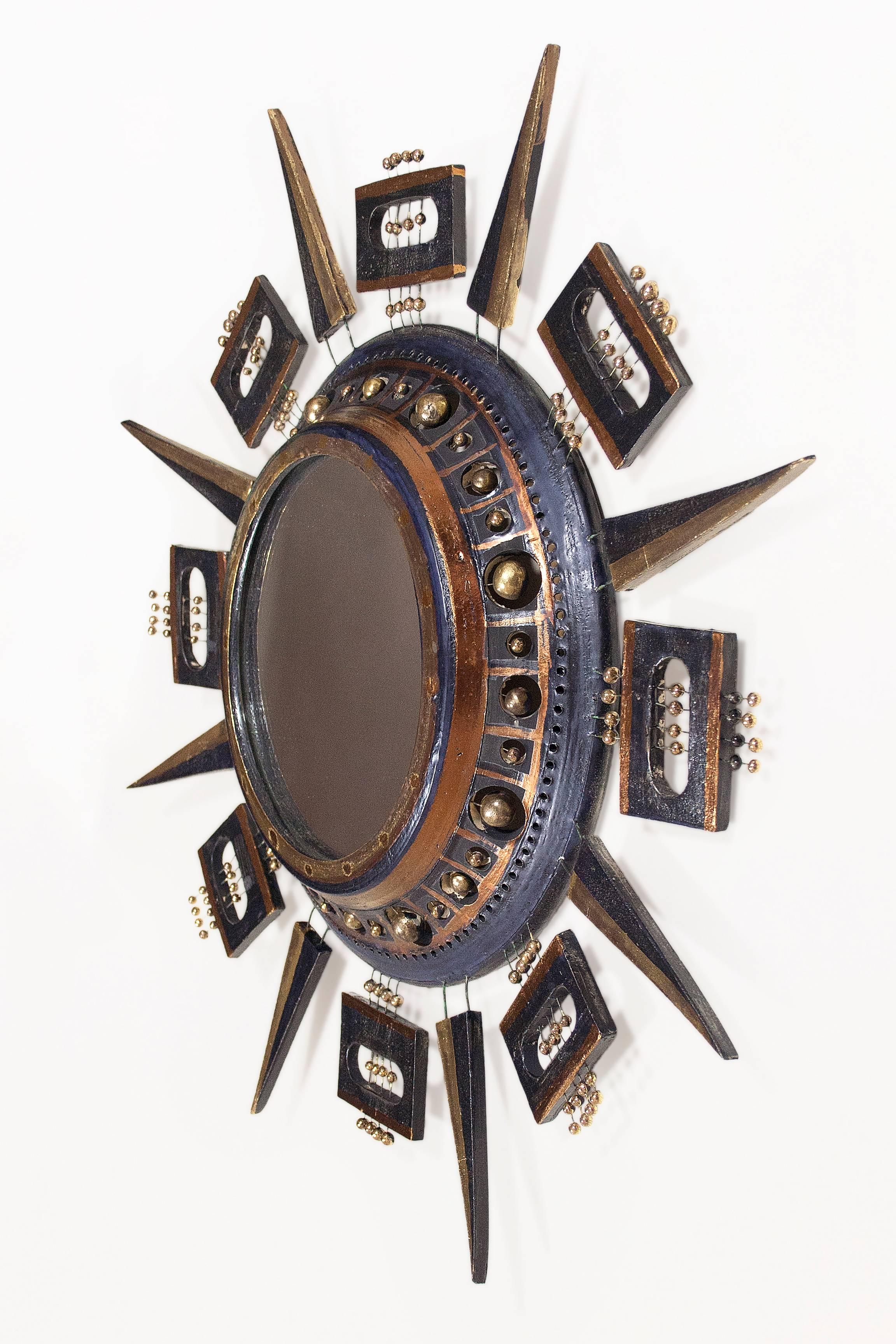 Ceramic sunburst mirror by Georges Pelletier 
Black and gold glazed ceramic 
Signed
circa 1970, France 
Very good vintage condition.