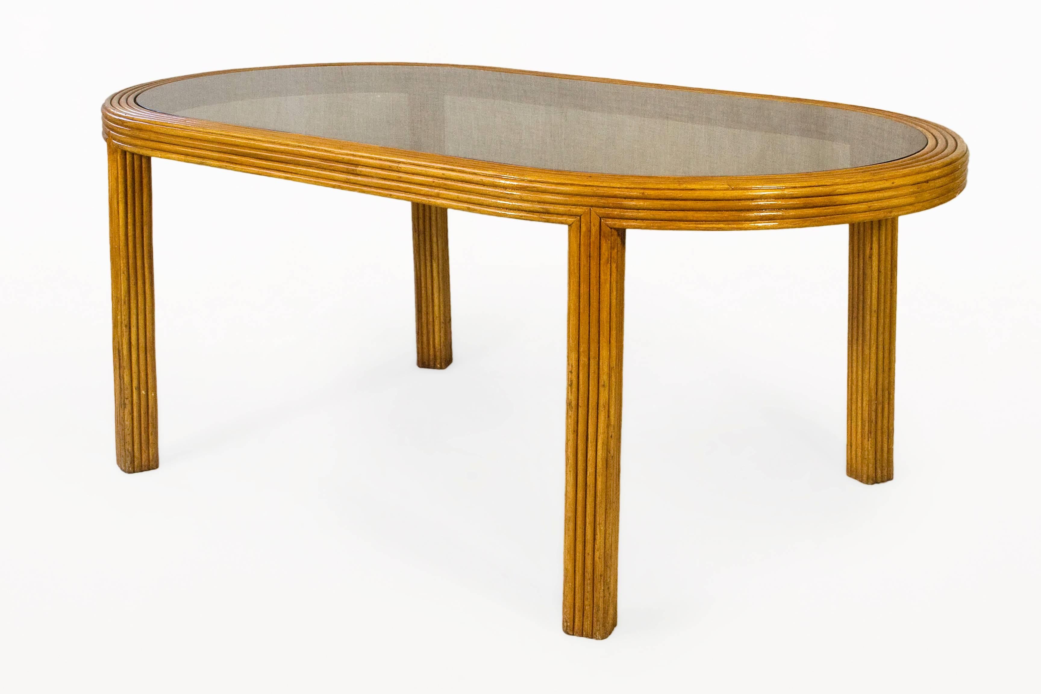 Bamboo and glass dining table in the style of Gabriella Crespi.
Oval design.
Slightly smoked glass top,
circa 1970, France.
Very good vintage condition.