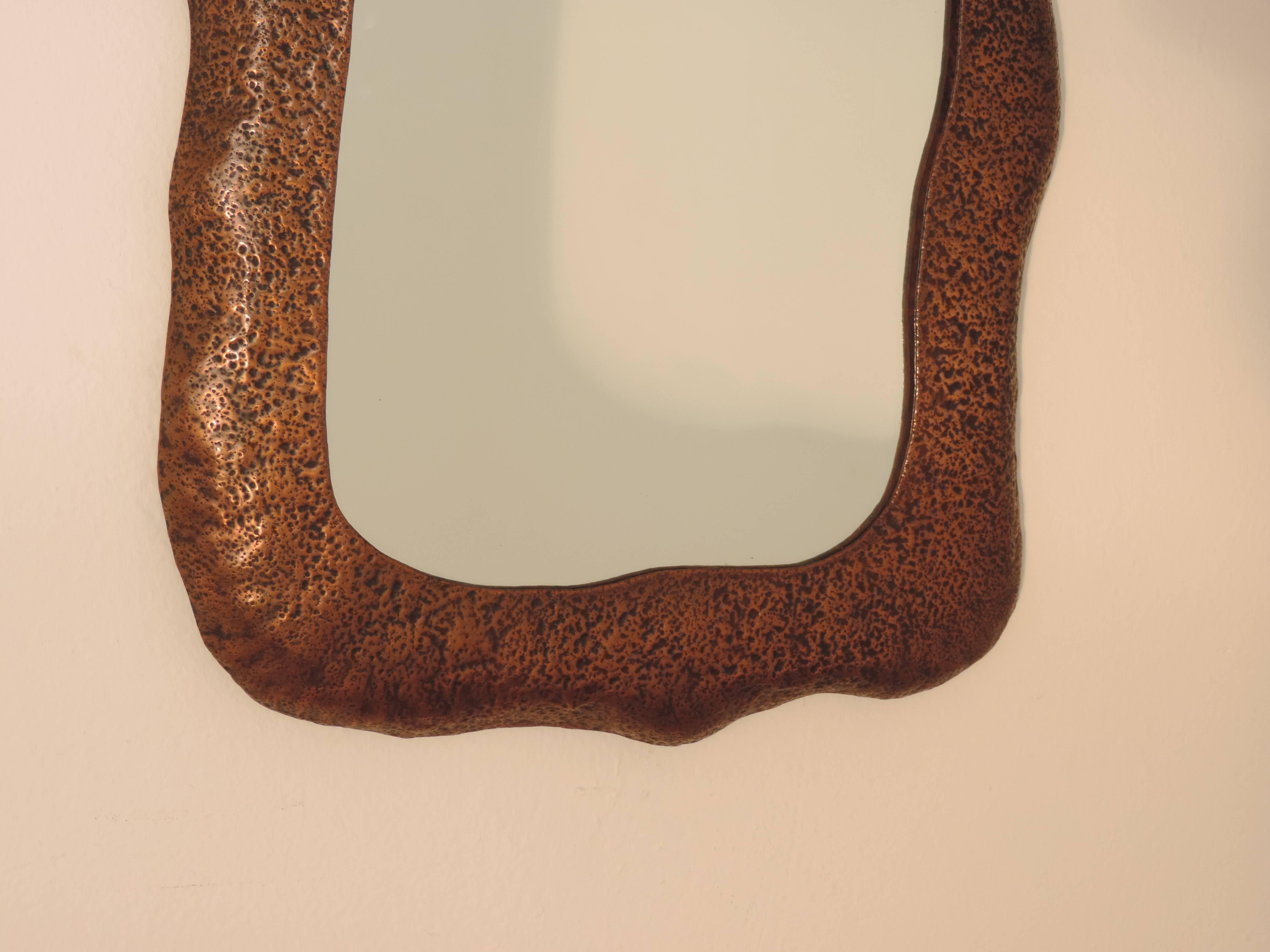A. Bragalini hammered copper wall mirror.