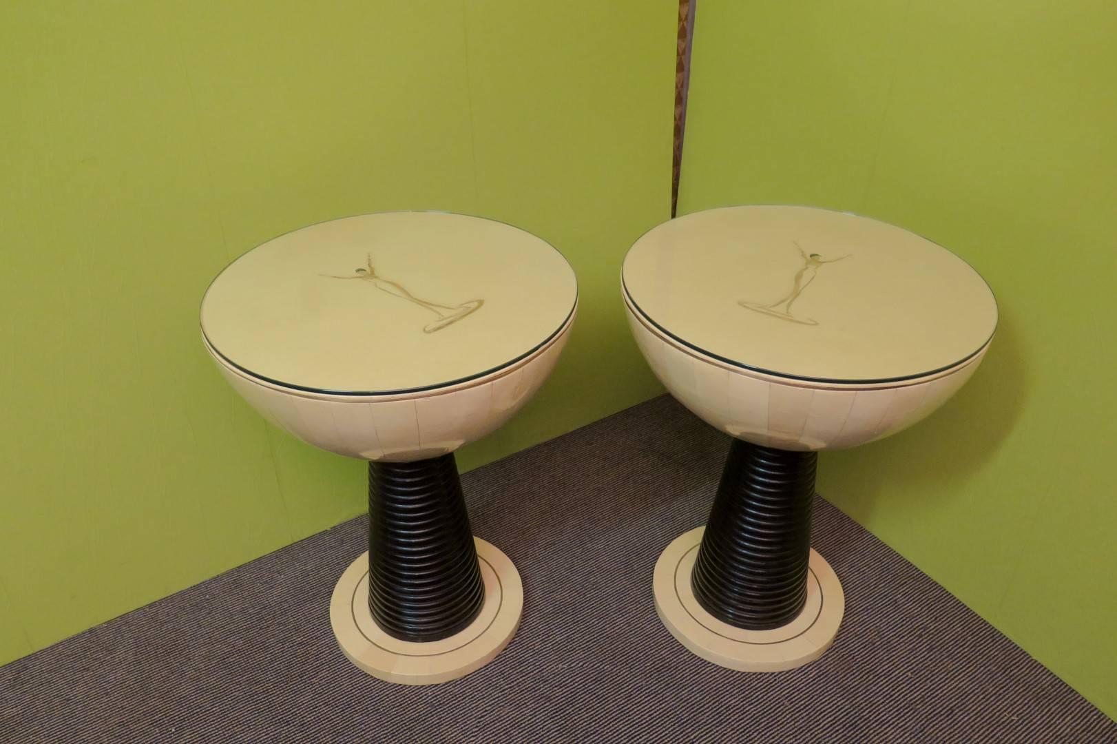 Very special side tables, shaped globe for these Art Deco side tables covered in parchment, with picture on the top, black lacquered wooden leg with foot in parchment and brass. Glass on the top.