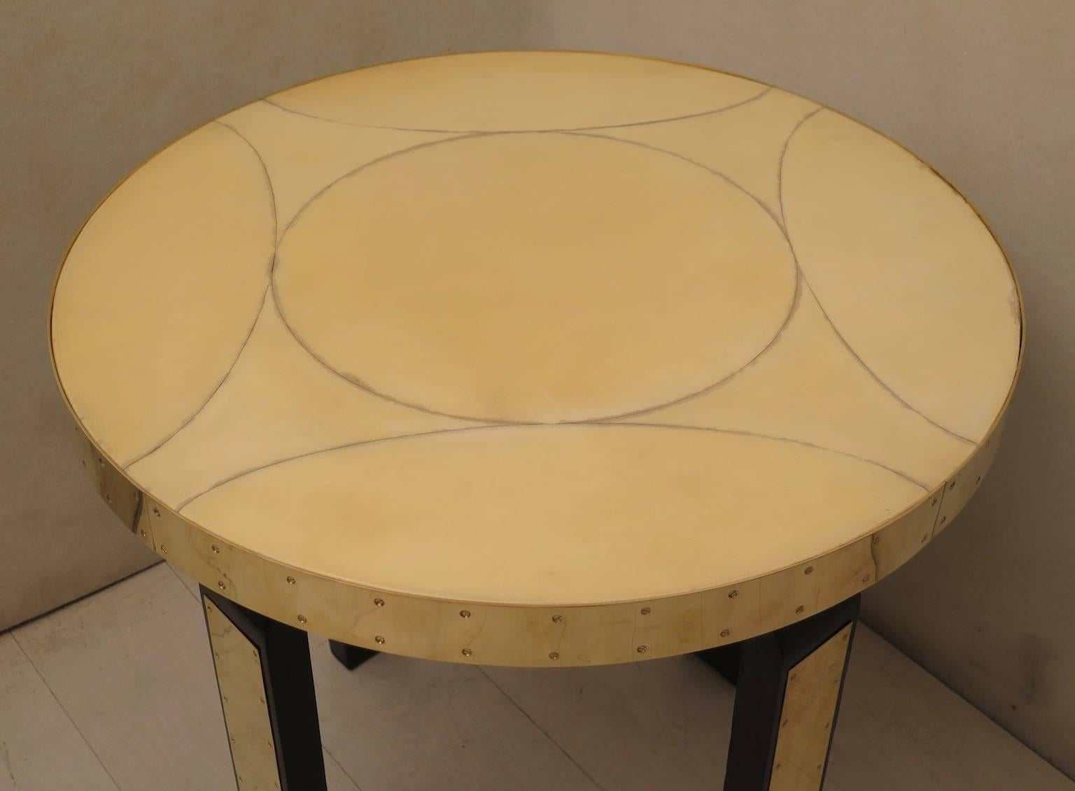 Tough Art Nouveau rigorous but simply amazing as a whole. Austrian Art Nouveau side table. 

Top covered in goat skin and polished in resin. Along the edge of the table runs a band of polished brass, held by small brass screws. The legs are all