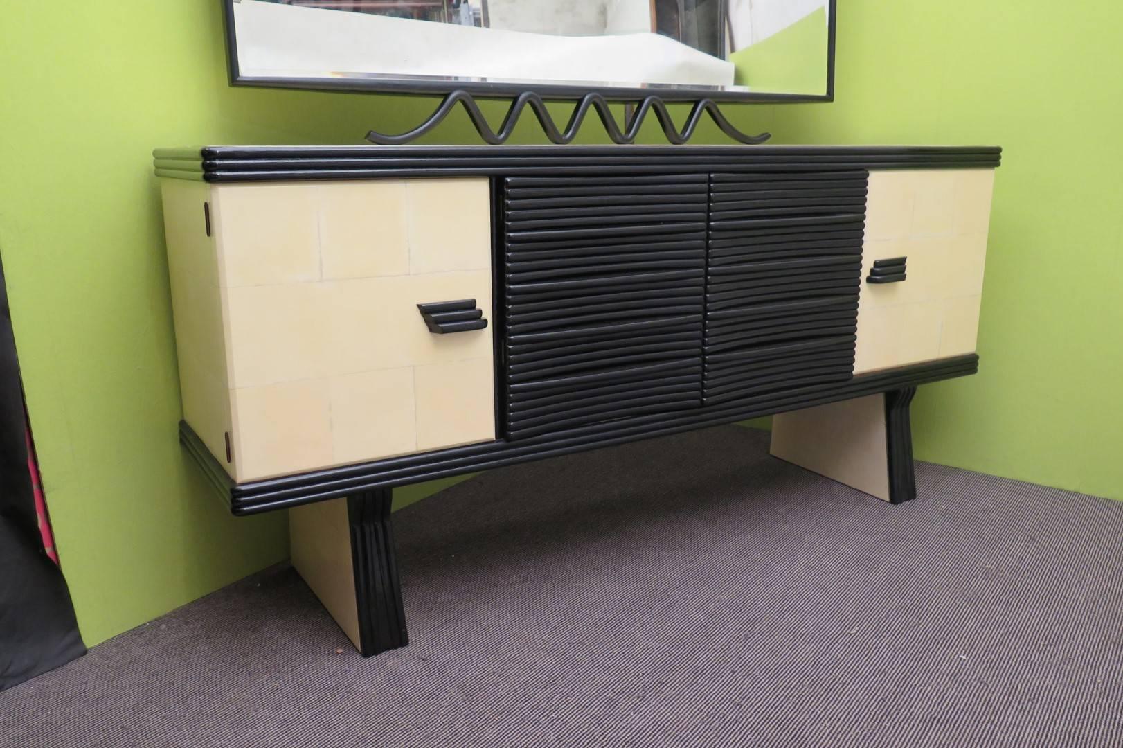Taste and Italian flavor for this typical sideboard of Pier Luigi Colli. Classic in his design but very refined in the process of working of the materials.

The sideboard consists of two side doors, and two central doors with two drawers underneath.
