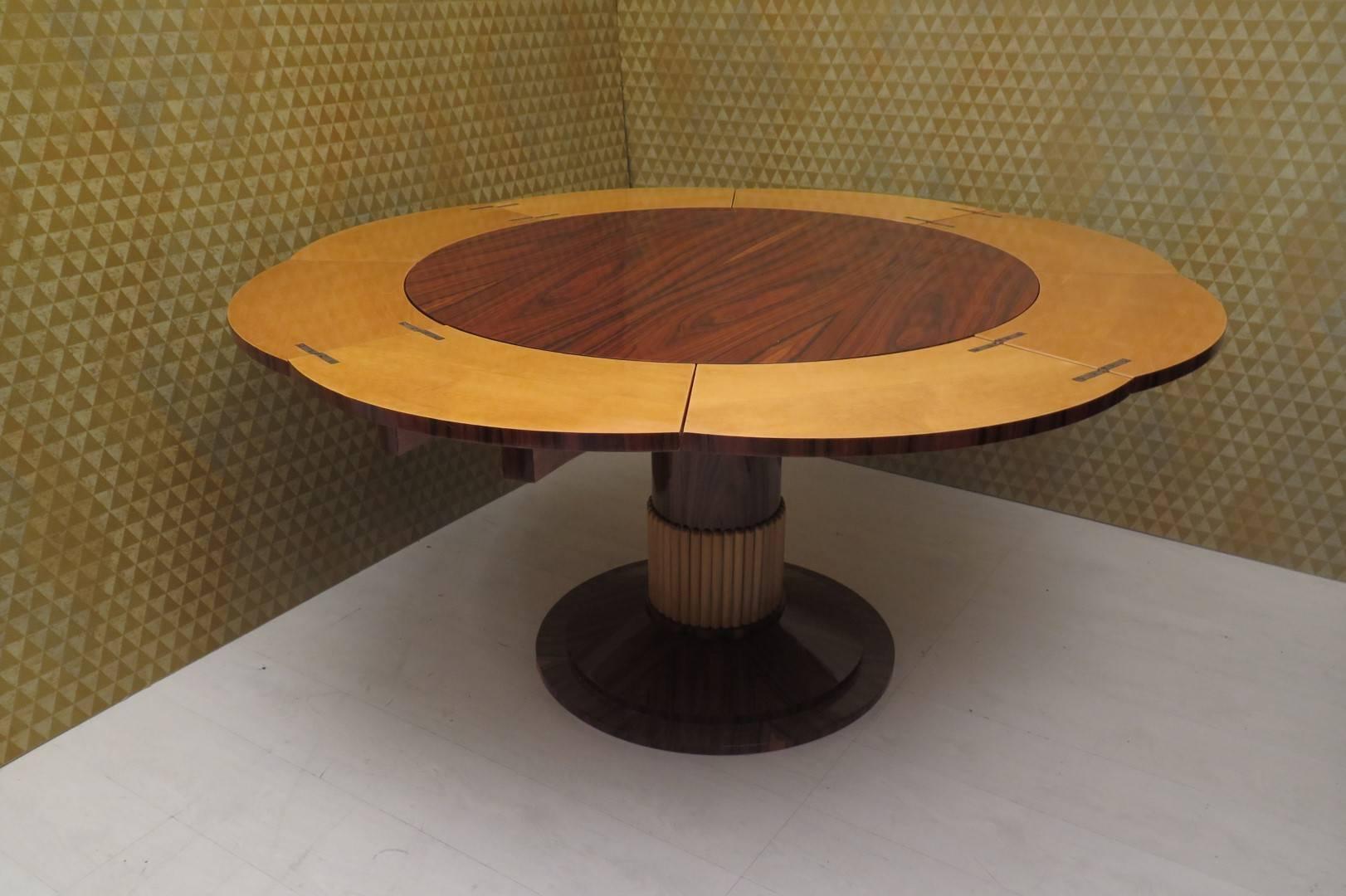 Italian Art Deco table. 

Walnut wood veneer with internal inserts in maple wood. The foot is central and fixed, also veneered all in walnut.
To notice a particular opening mechanism like a 