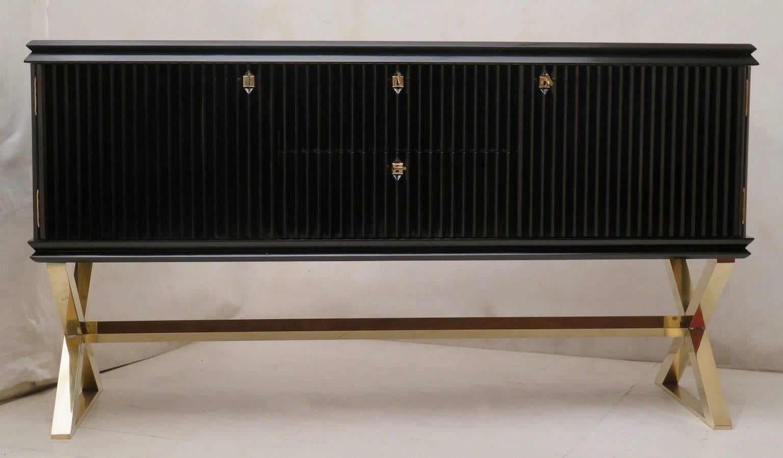 1950 Italian midcentury sideboard. All polished in black shellac, with polished brass leg. The body of the sideboard is composed of two side doors and two central drawers. Its top is smooth and polished all black. The sides and the front of the