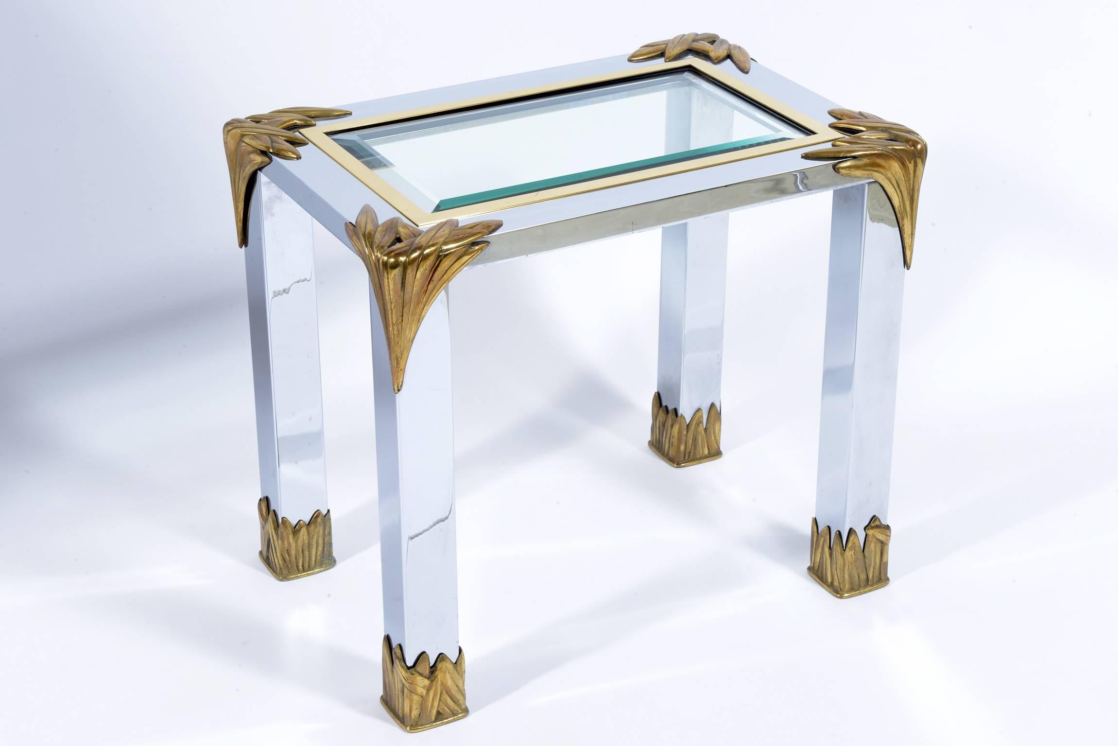 Pair of steel structure side table with vegetable cut brass details in the corner and feet , thick beveled glass top.