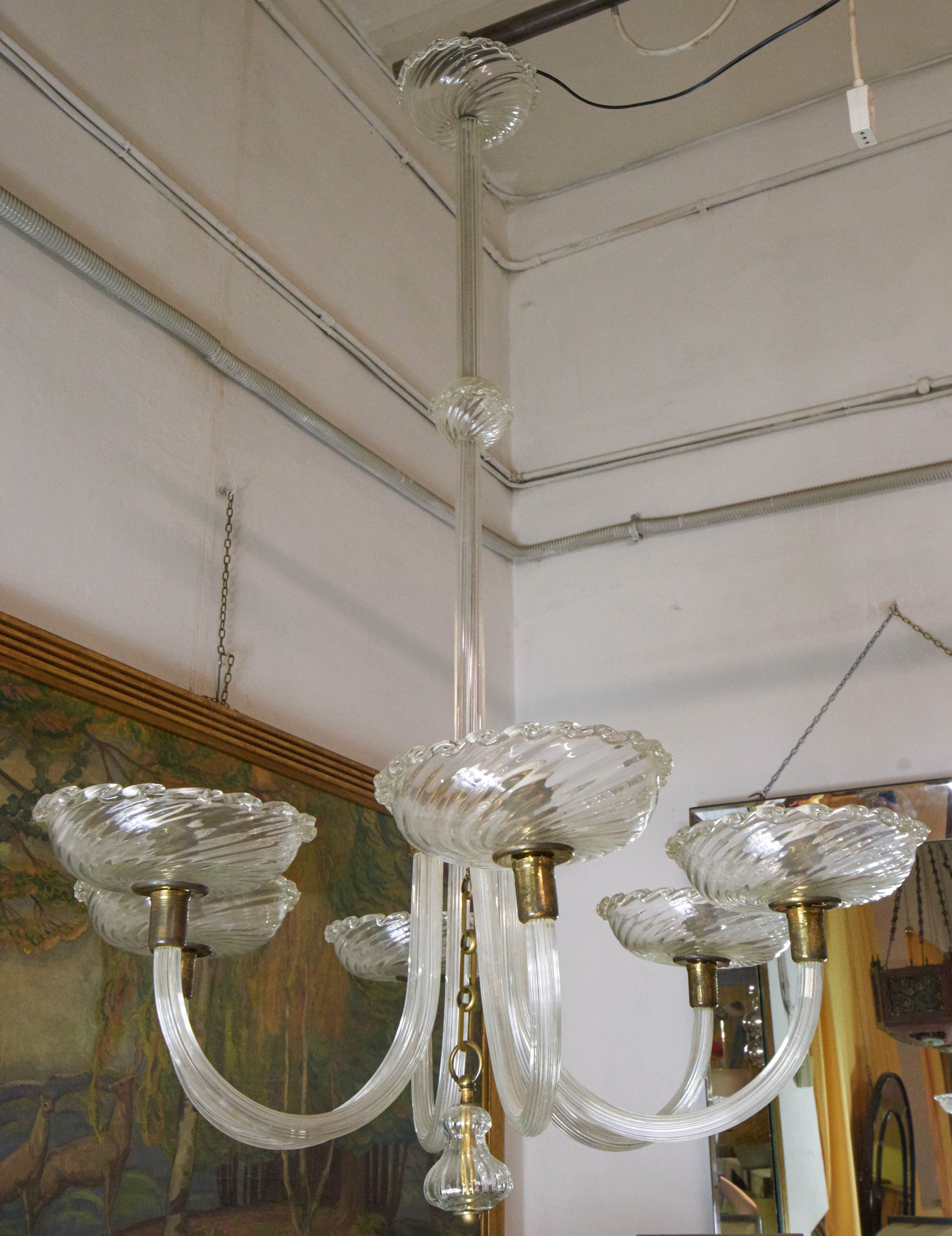 Elegant 1940s chandelier by Barovier. Six-arm and bulbs no colored Murano glass and brass details.
Mid century modern
