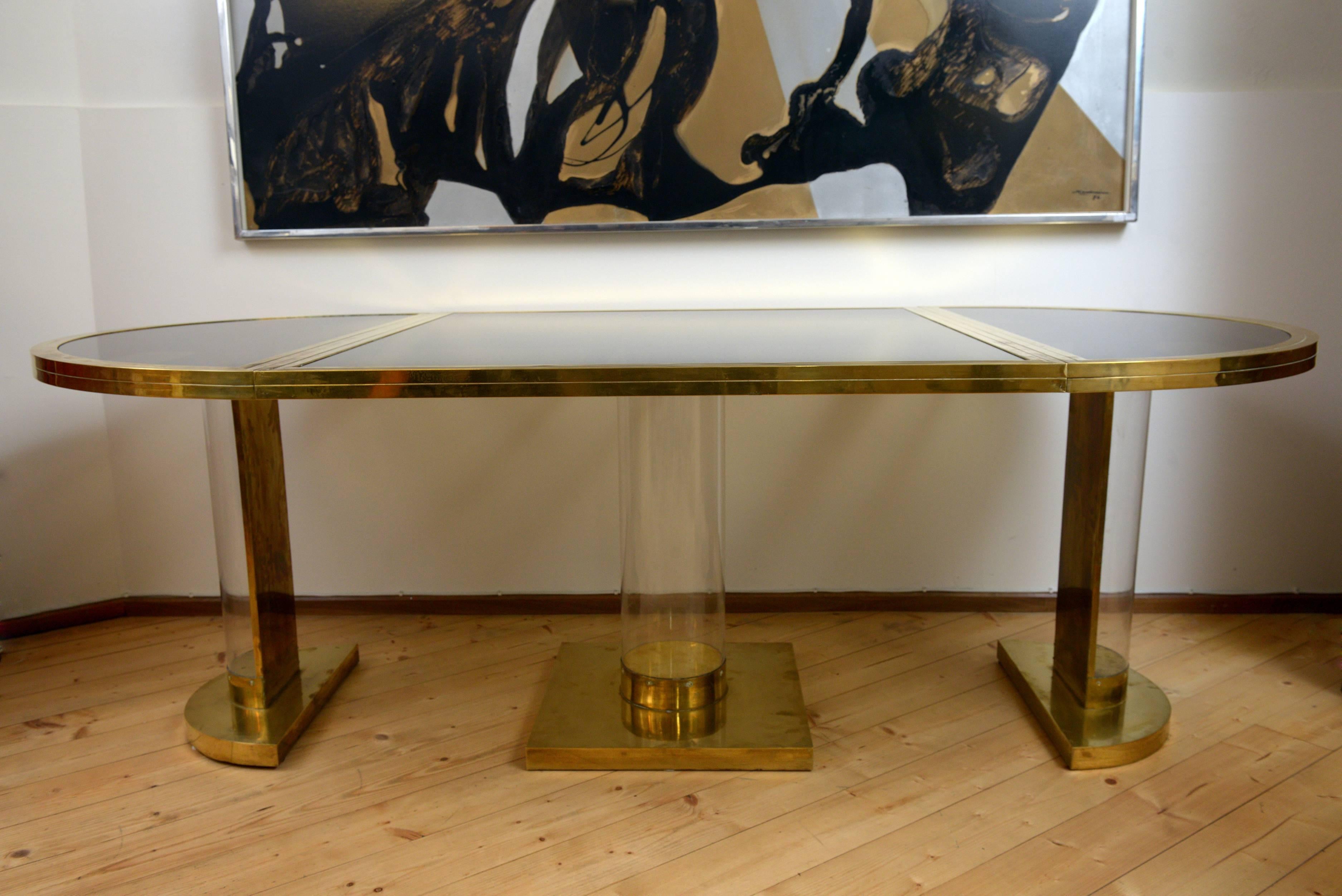 This dining table, brass smoked glass and plexiglass can be easily divided and becoming two demilune consoles (cm 110x 55) and a square table cm (110x110), or combining the two consoles in a round table (diameter cm 110 ) you can have two tables,