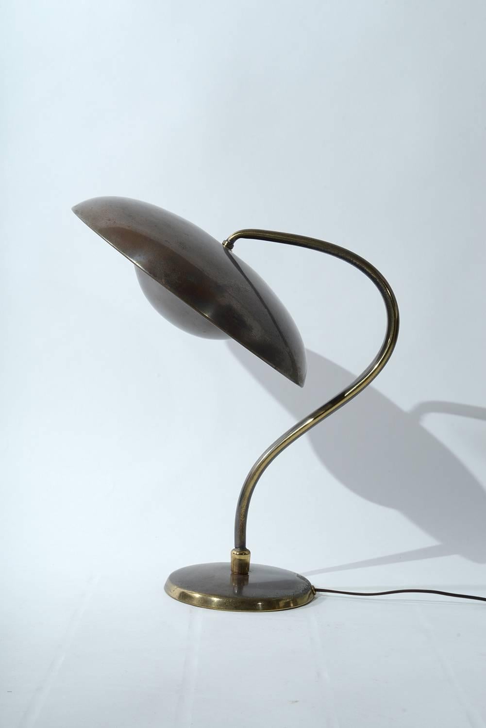 Bronzed brass table lamp with adjustable shade.
Two bulbs inside a diffuser.
  