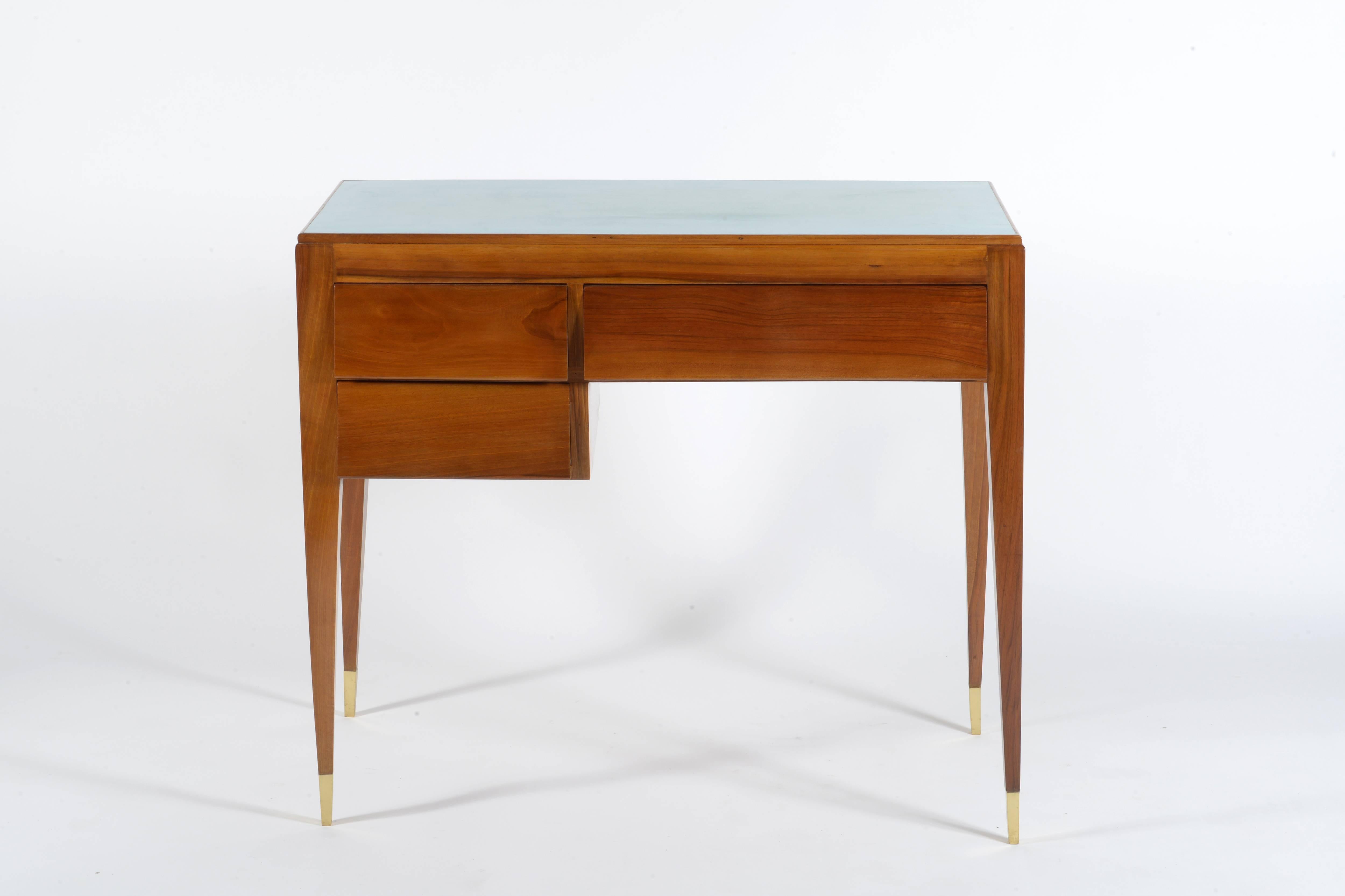Four slender legs with bronze end feet, three inclined drawers.
Solid walnut and formica top.