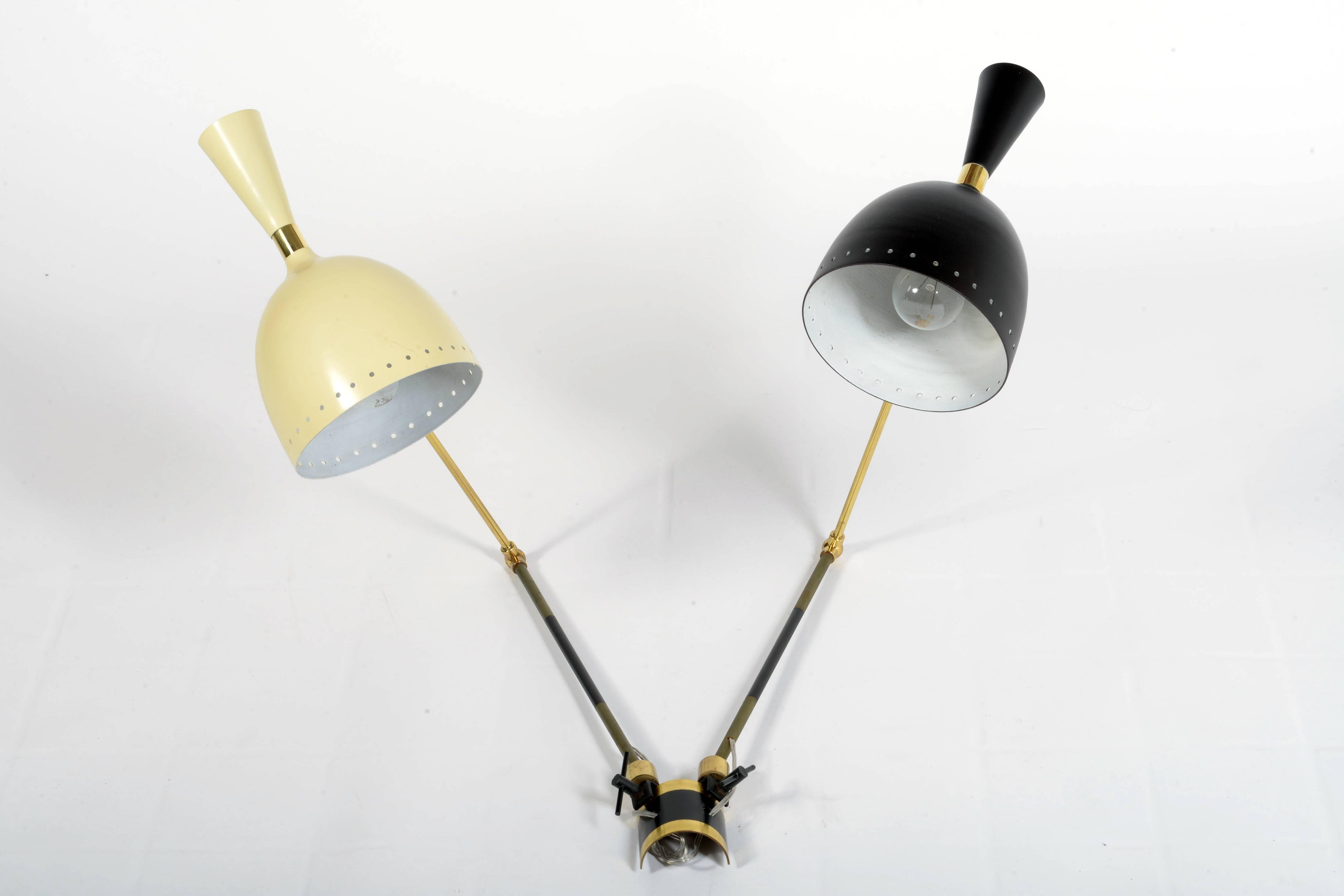 Wall light, double arm and double light each. Brass adjustable structure with many movements, black and crème color lacquered diffusers and details.

The measures depends on the movement and on the change of the position.