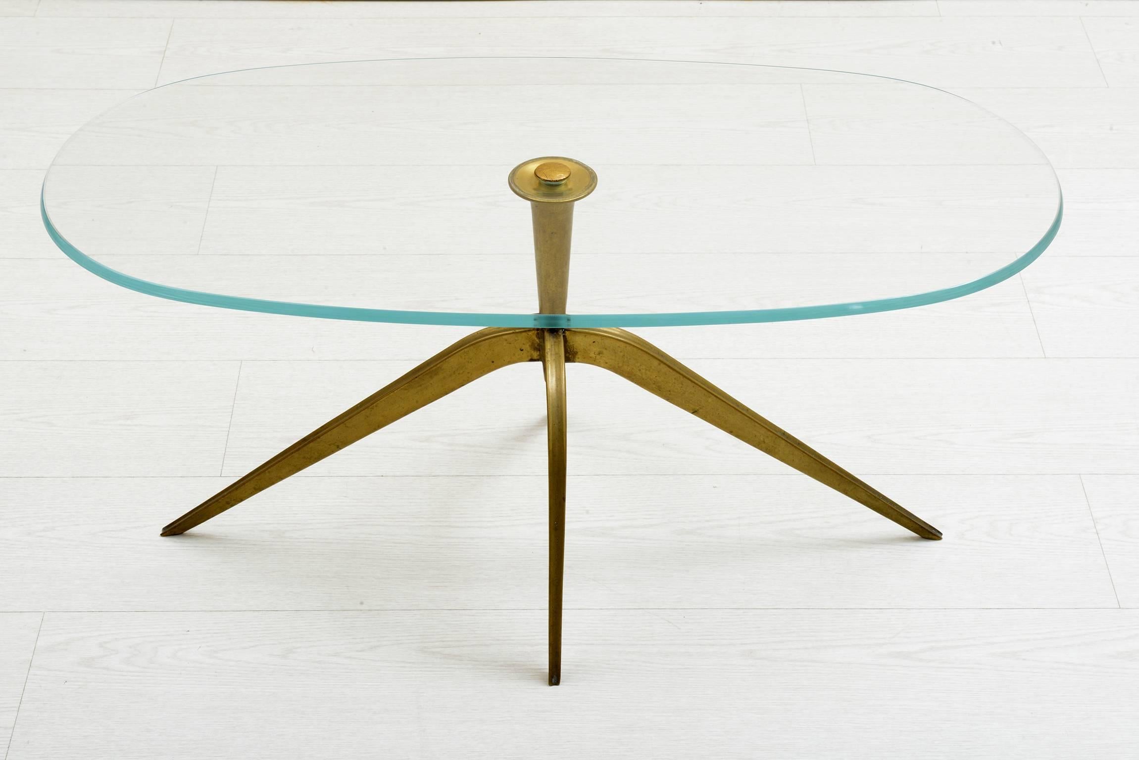Bronze base with four slender curved legs, beveled oval tempered glass top.
 