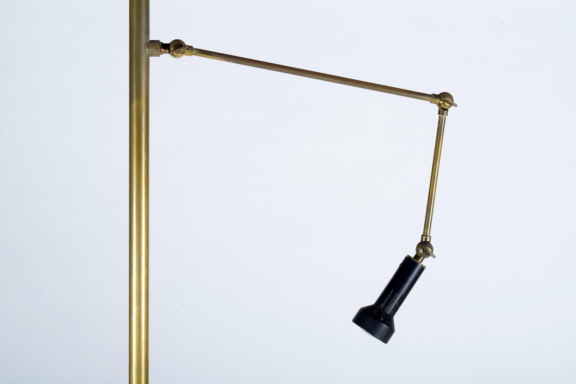 This cavalletto, easel floor lamp was designed by Angelo Lelli for Arredoluce model '12377', circa 1951. The Italian lamp features golden brass and black lacquered diffuser.
This icon of the Italian Mid-Century design has adjustable arms for