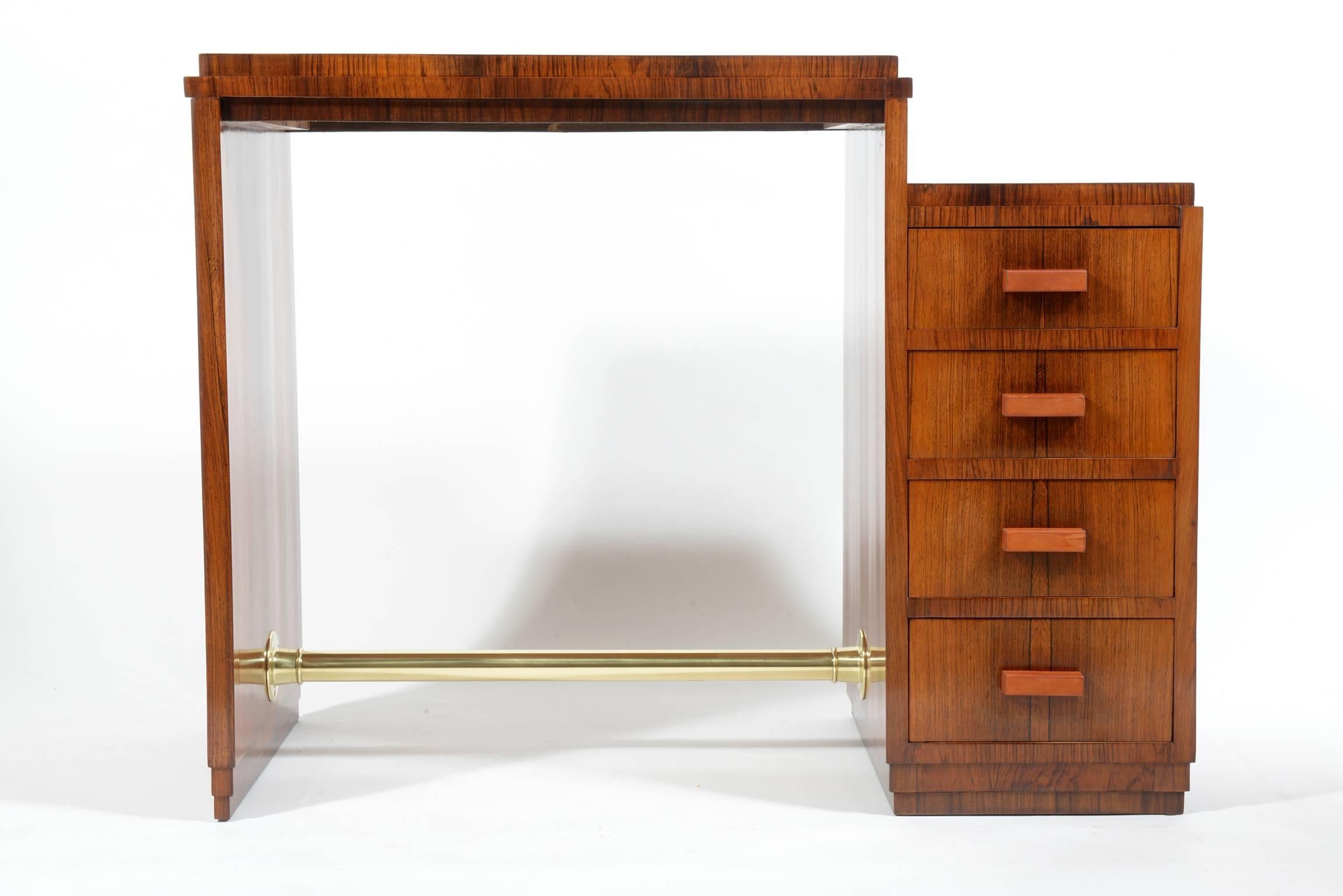 Rationalist little writing desk in exotic wood, four drawers with handles covered in natural leather.
Interesting decorative Art Deco details construction.
Brass footrest.