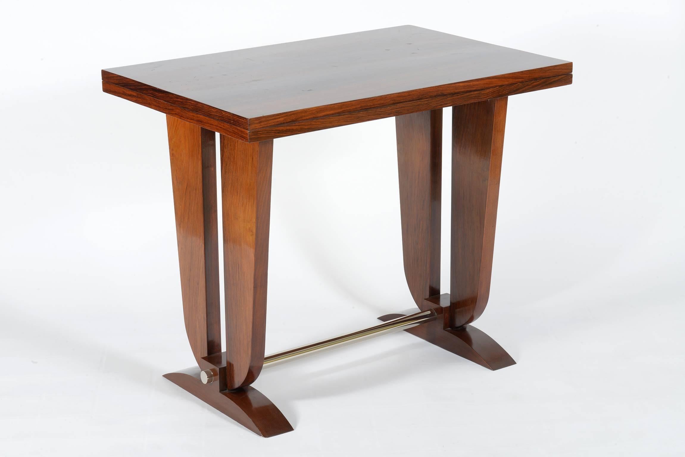 Two side supports joined by a chromed brass footrest bar.
The top rotates to open it and doubled.
Precious exotic wood is on the top when closed and opened.
When the table is open the measuere of the top are: cm 120 x 90
inches 47 x 35.5.
