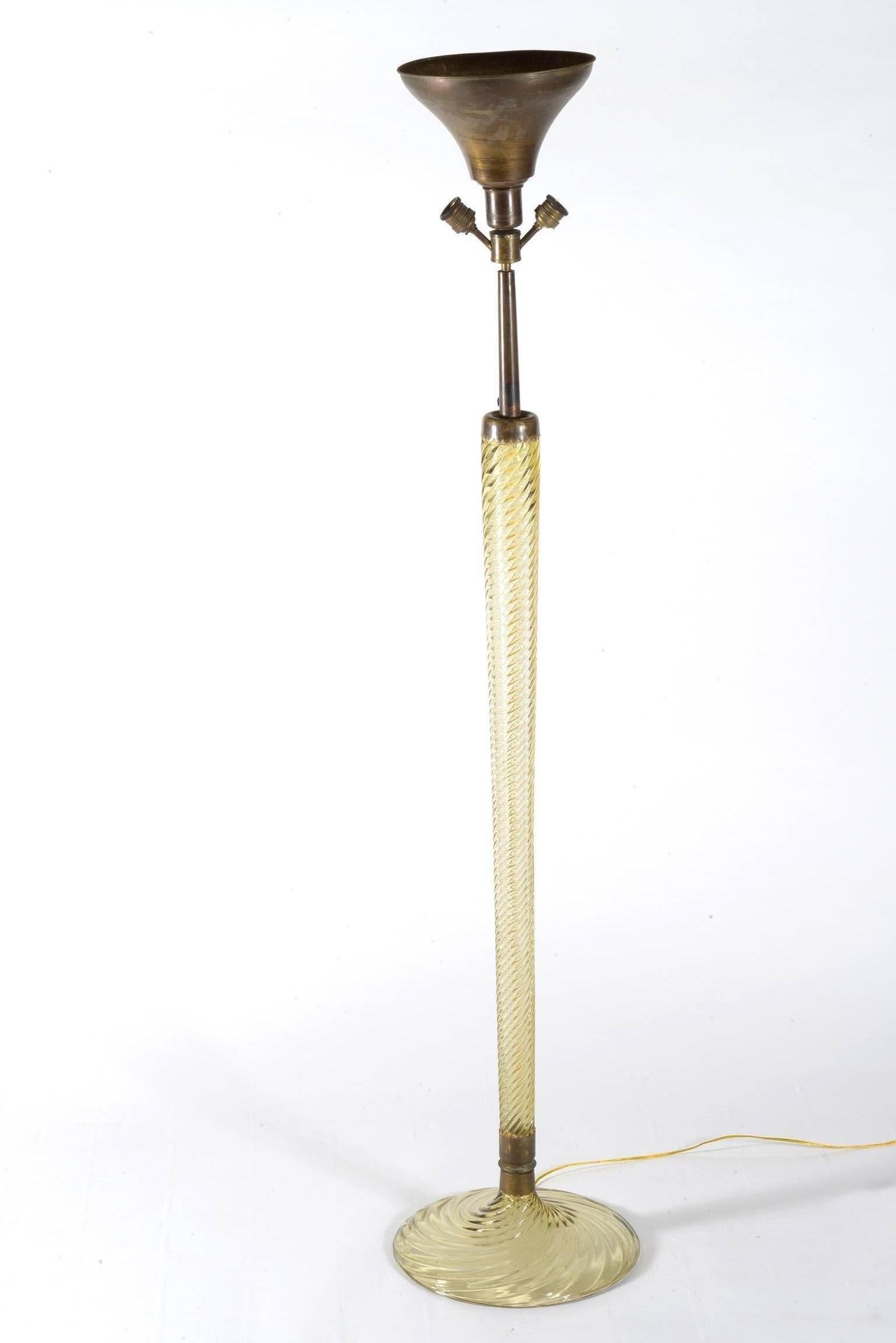 Midcentury blown honey color Murano glass floor lamp, the stem is one big blown segment where the electrical wire goes through, the base is also on glass.
Three bulbs.
Published in the Venini book and realized in the 1942 during the direction of