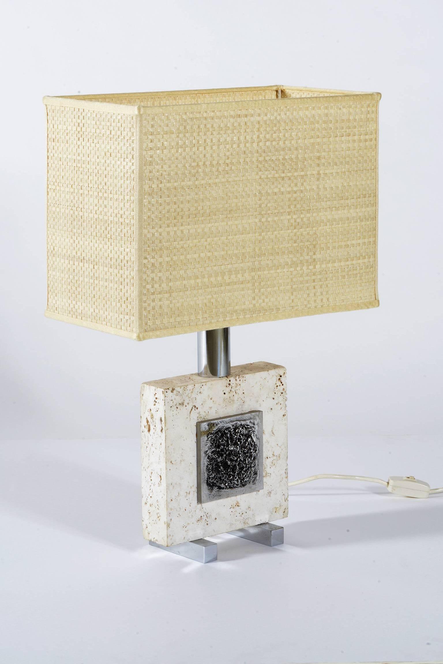Italian 1970s pair of lamps, a piece of travertine support two chrome metal bass relief applied on each side.
Chrome metal feet.
The shades are new.
The listed measure are with shades.
The price is for two.