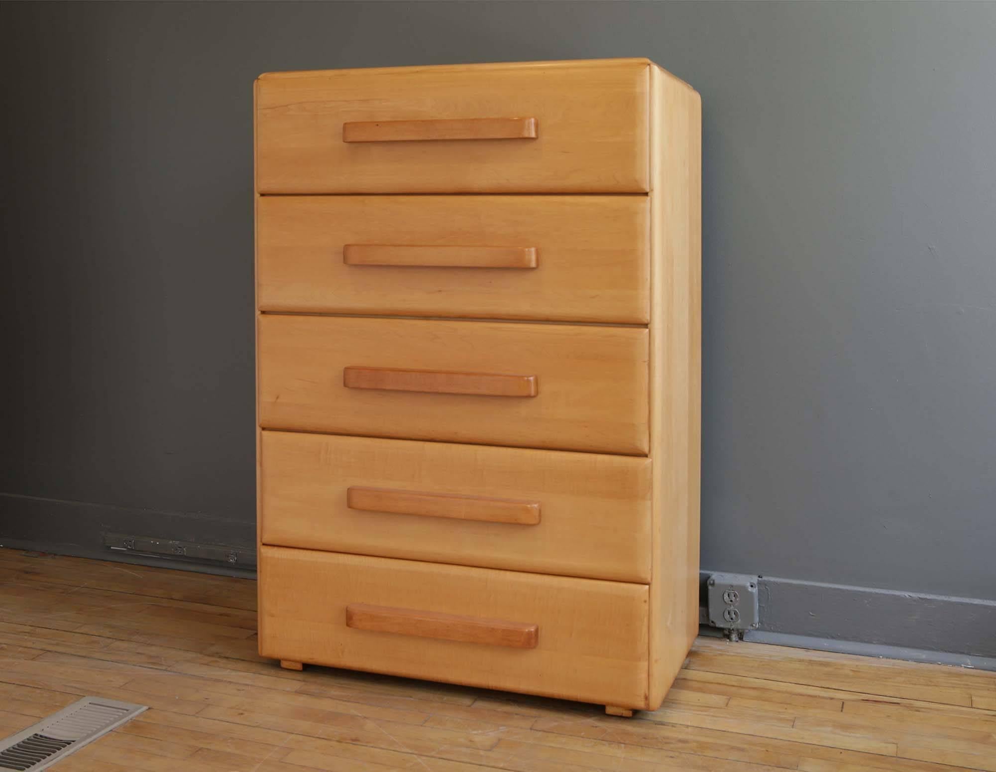 A tall chest of drawers or bureau designed by Russel Wright for Conant Ball, circa 1930s. Consisting of a solid maple case featuring five deep maple drawers each with a large sculptural handle. Recently refurbished in a natural finish and in