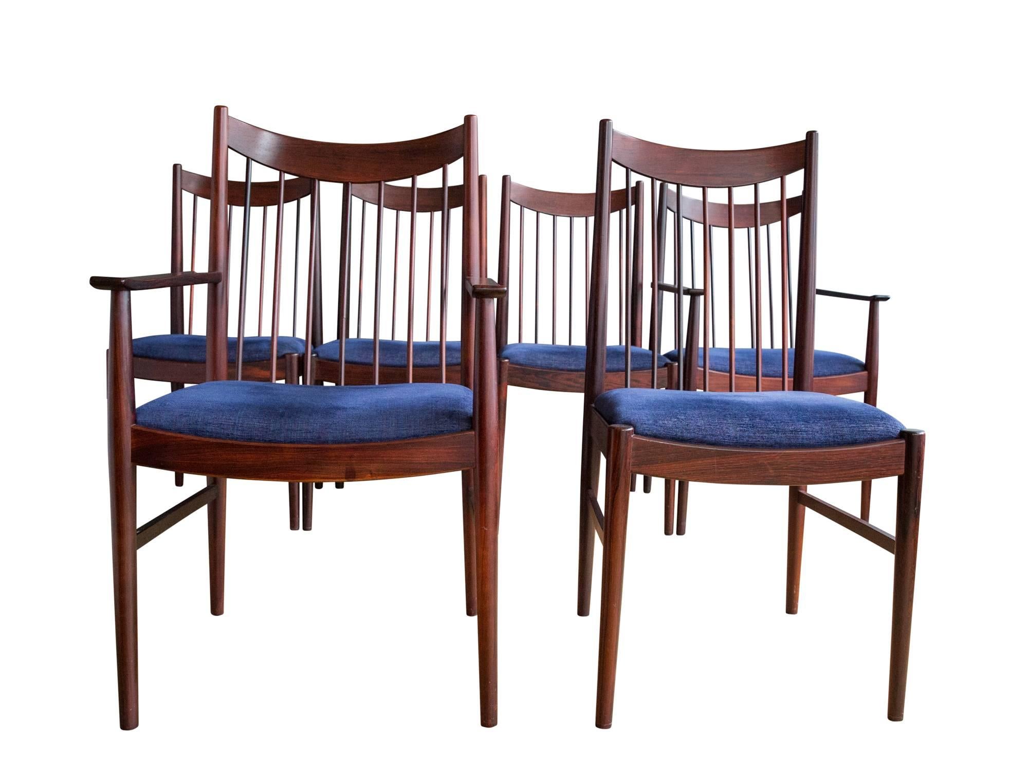 A set of six Model 422 high back dining chairs by Danish designer Arne Vodder for Sibast, circa 1960s. Featuring slender rosewood frames with slanted spindle backs and elegantly curved backrests. Set consists of two arm chairs and four side chairs.