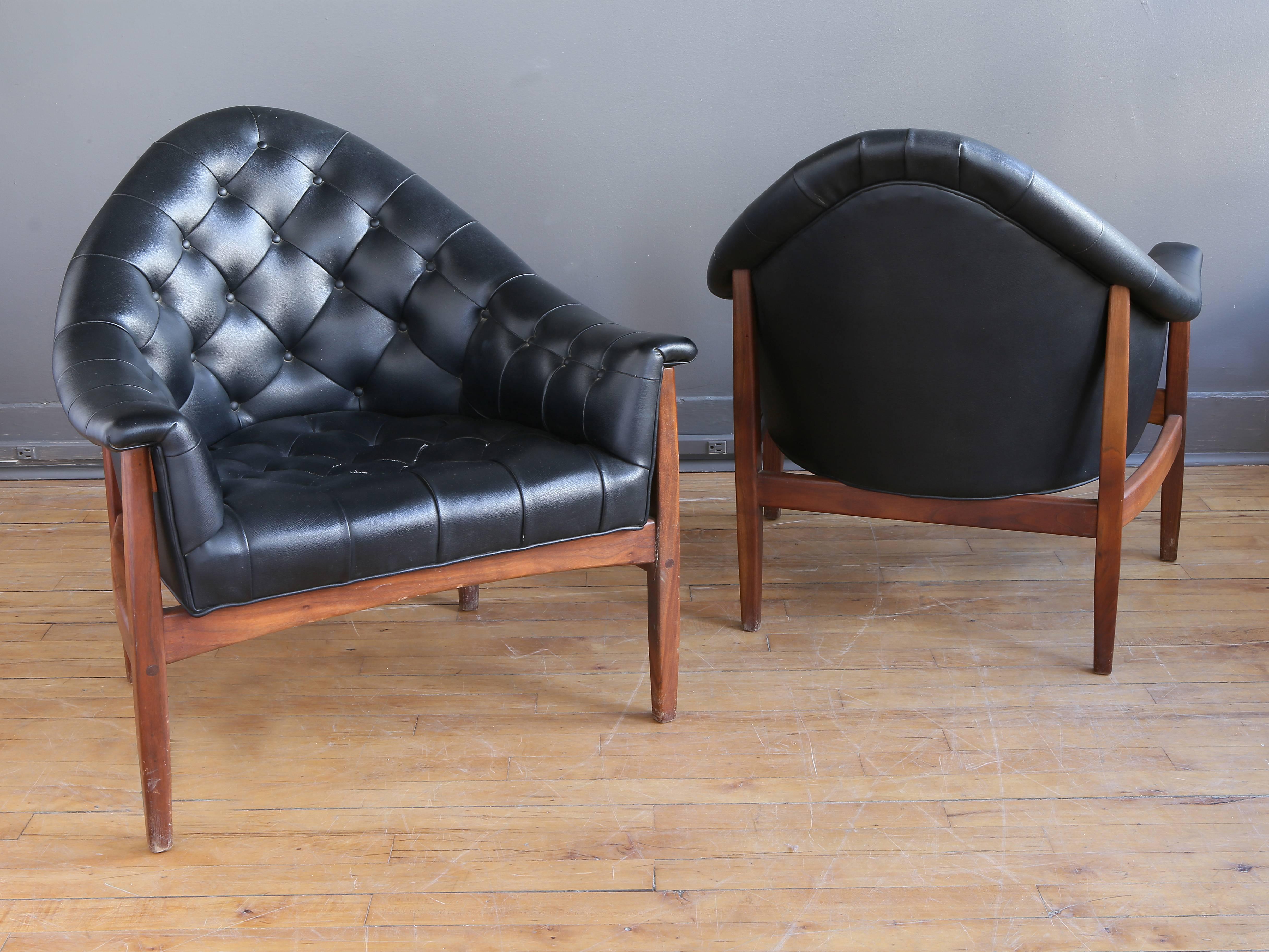 A pair of tub lounge chairs designed by Milo Baughman for Thayer-Coggin, circa 1960. Featuring nicely made walnut frames and high barrel backs. 

Versatile in size with a comfortable and accommodating form.

Please contact dealer to discuss