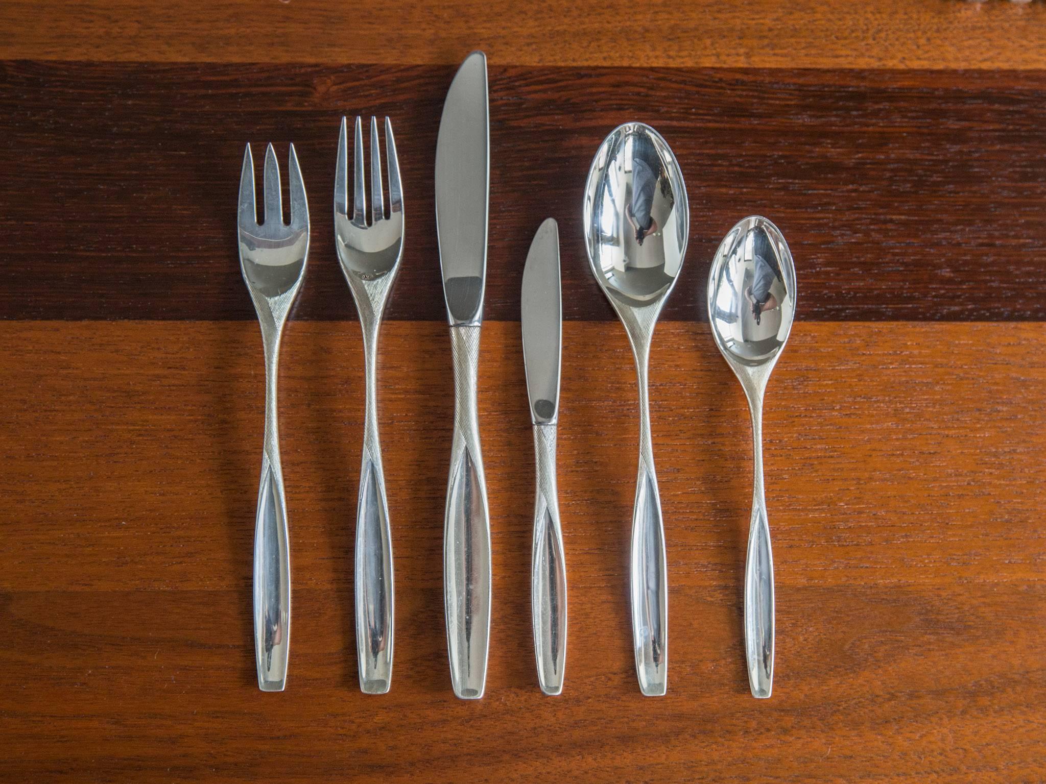 A 55-piece sterling silver flatware service in the "Ellipse" pattern by Kirk, ca. 1960s. Featuring eight 6-piece place settings which include a tea spoon, soup spoon, butter knife, dinner knife, salad/dessert fork, and dinner fork. Seven