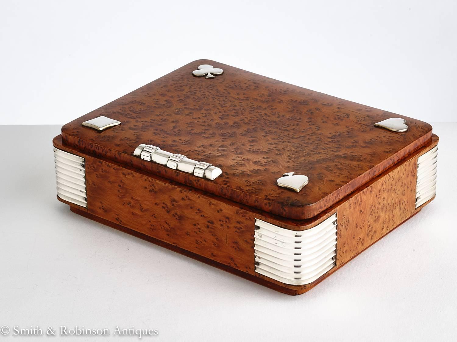 20th Century Art Deco burr walnut games box with applied silver decoration, France, circa 1925.

Stamped 800 silver on the bullnose corners.

The interior has its original pieces but the playing cards have been replaced.

We are always adding to our