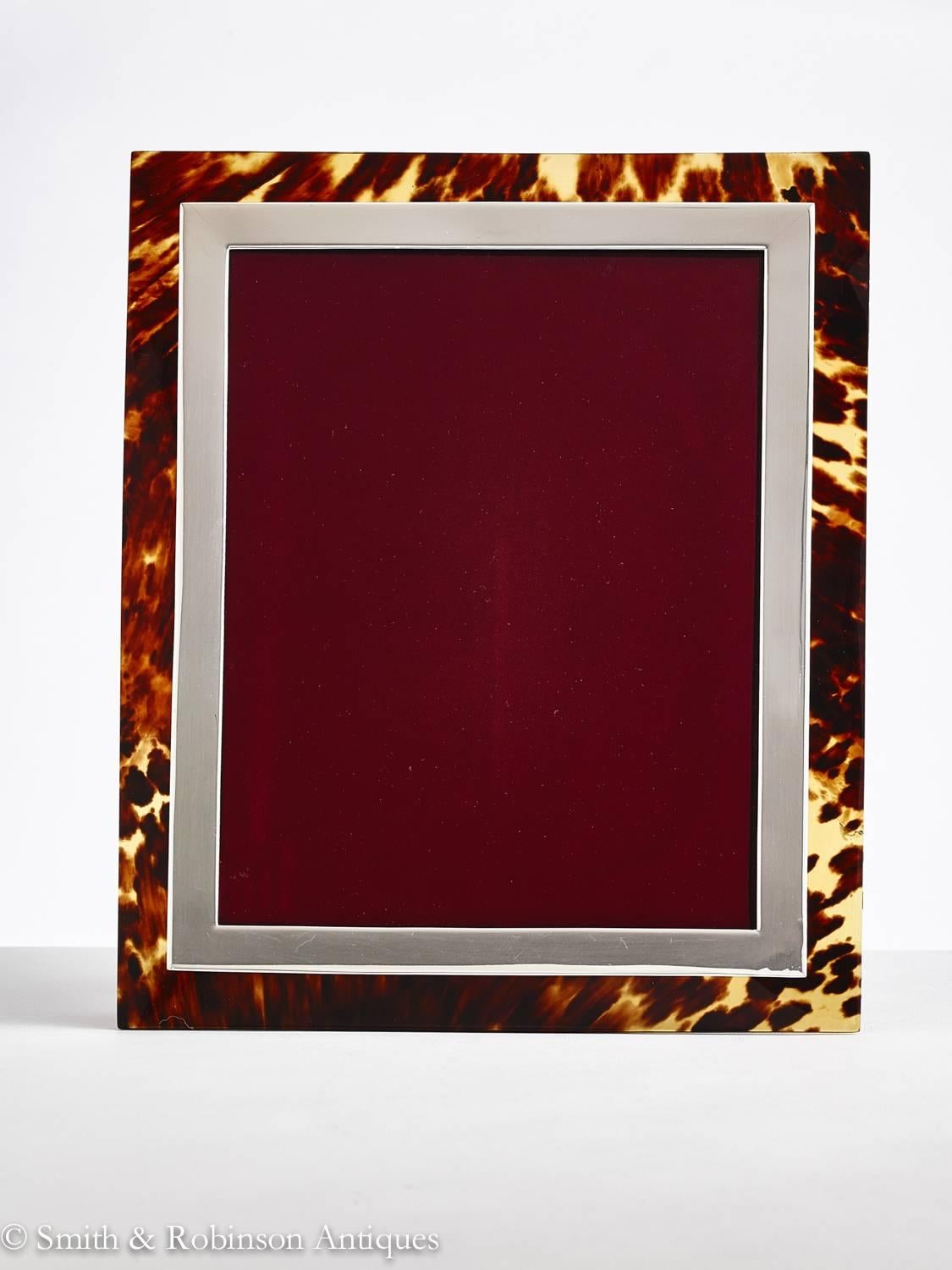 A beautiful Art Deco tortoiseshell photograph frame by Finnigans of New Bond St., London 1922.
The fine shell has a very attractive light and shade patina which looks stunning when back lit.
The cast silver gives adds to the overall quality and it