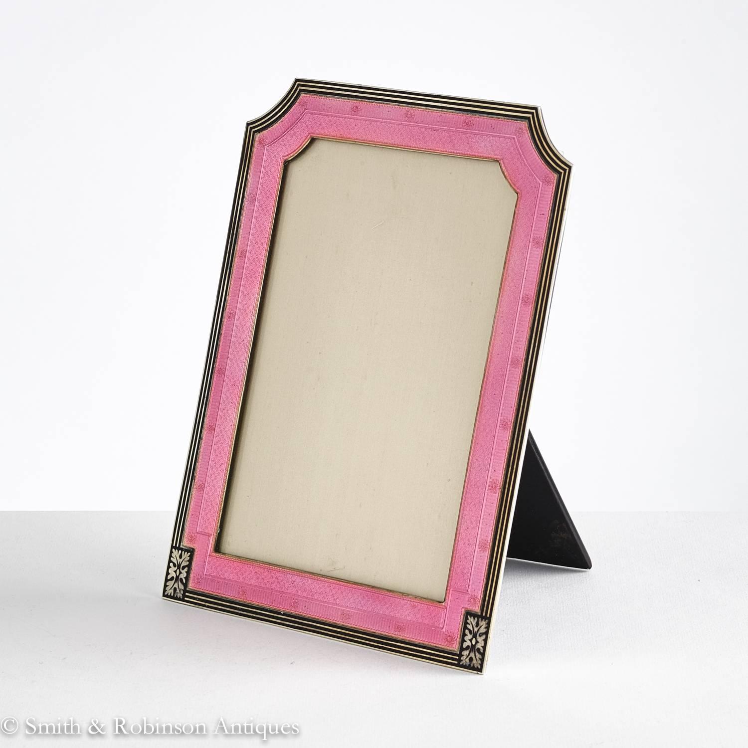 A stunning quality Art Deco silver and enamel photograph frame by maker Henry Mathews and dated Birmingham 1923.
The silver is cast and all the under decoration on the silver is very fine.
The pink enamel has a translucent sheen. 
The Leading