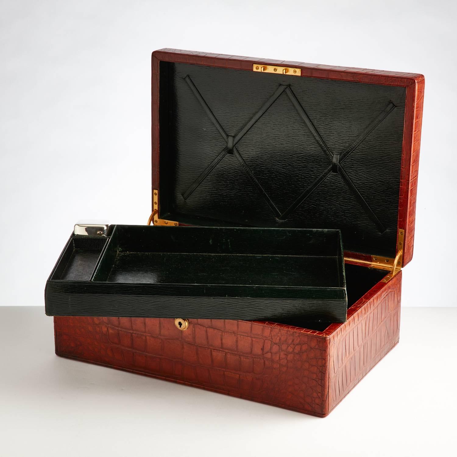 A large stunning vintage crocodile document box in excellent condition with gilded recessed carrying handle and a brahma spring lock with key.
The exterior colour is London tan and there is just a slight colour difference to the bottom front left
