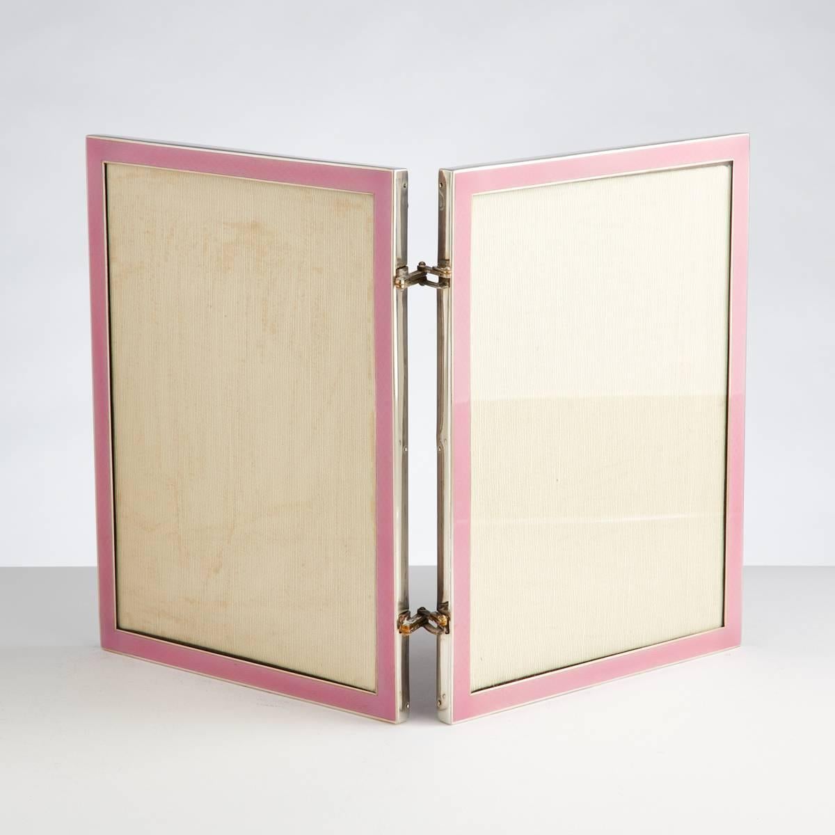 An Art Deco double silver & enamel  photograph frame.
The vibrant pink enamel really sets it apart.
The hinges allow the frame to be opened in two directions.
The silver is dated Birmingham 1927 by maker Samson Mordent.
It retains its original