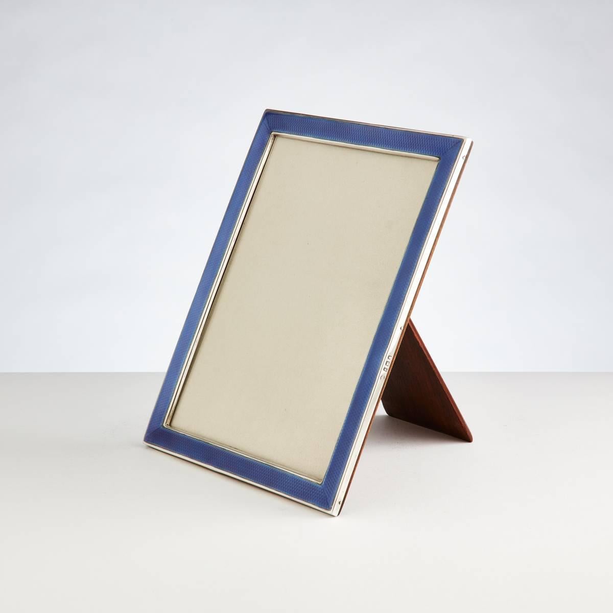 Art Deco purple silver and enamel photograph frame by maker Aide Bros, Birmingham, 1923.

Complete with its original oak back.

Measures: H 9 1/4", W 7 1/4" 
opening 6" x 8"

