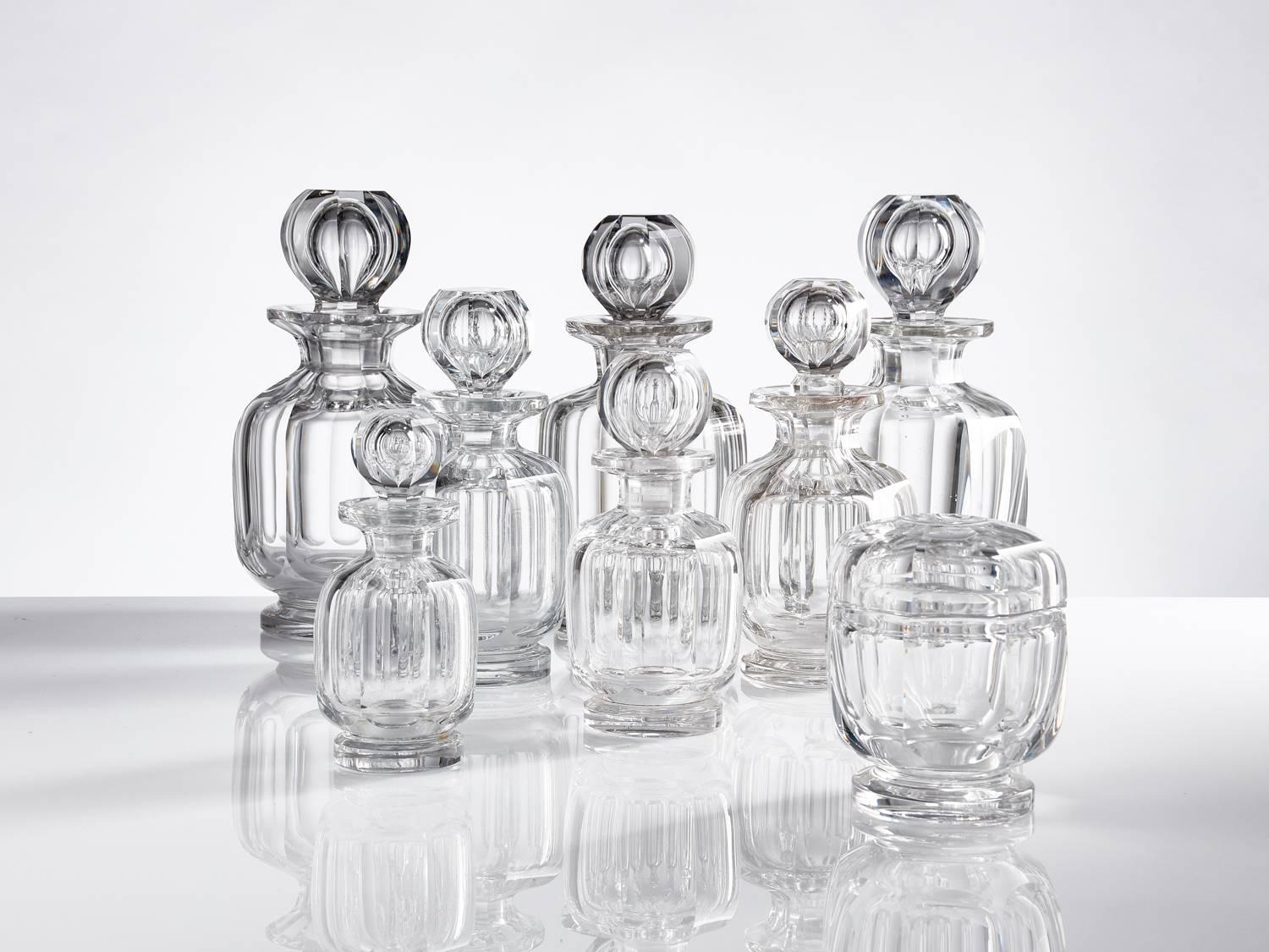 Collection of mid-20th century Baccarat glass toiletry bottles, French, circa 1950 
Comprising of eight items all stamped on the base.
These pieces are all in excellent condition.
Largest 8 1/4
