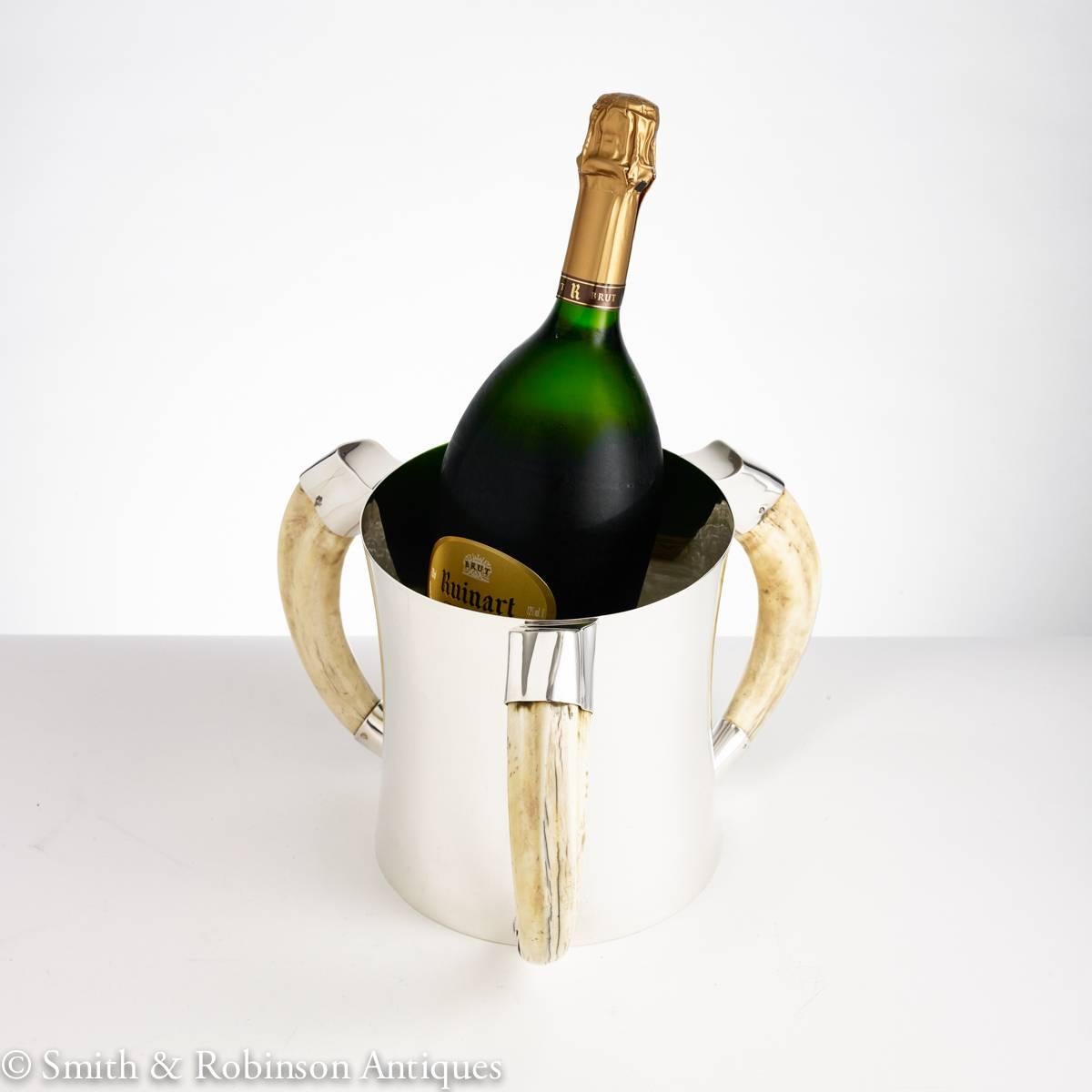 A rare and stunning heavy gauge silver champagne or wine cooler supported by three wild boar tusk handles dated London, 1908 by maker William Hutton & Sons.

We are always adding to our 1stdibs catalogue so be sure to add us to your favorite