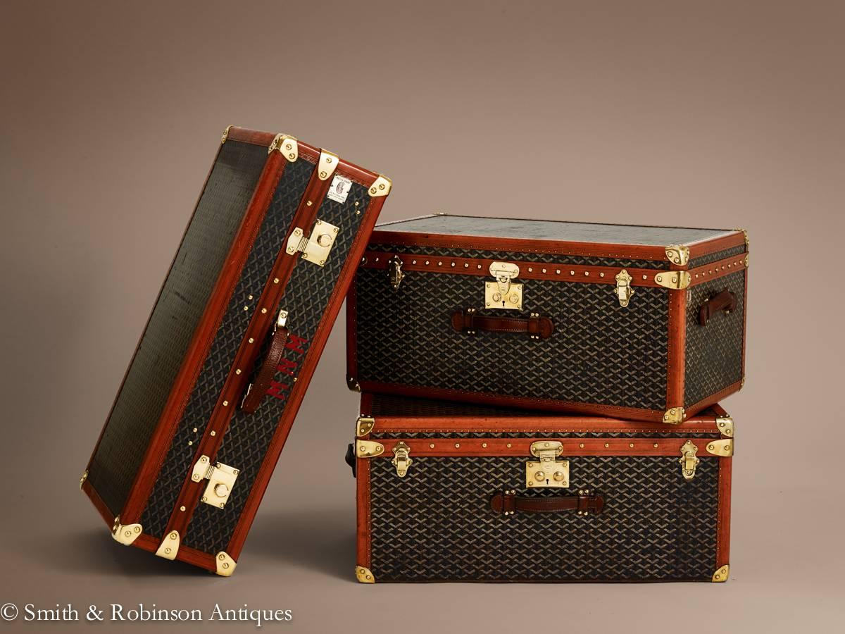 This superb three-piece consists of a pair or Goyard trunks and an unusual Goyard wardrobe with the following details.

The pair of trunks are complete with original labels and markings for 1920.
The interiors are lined in linen the brass locks