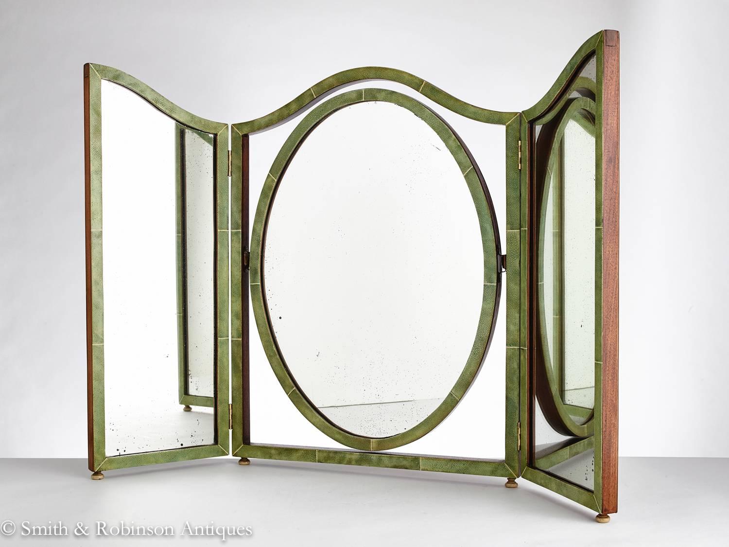 A beautiful Art Deco three fold vanity mirror with its original plate mirror, English circa 1930.

The shagreen panels are beautifully matched with a mellow patina.

The centre section has the oval shape which is quite rare and is fully