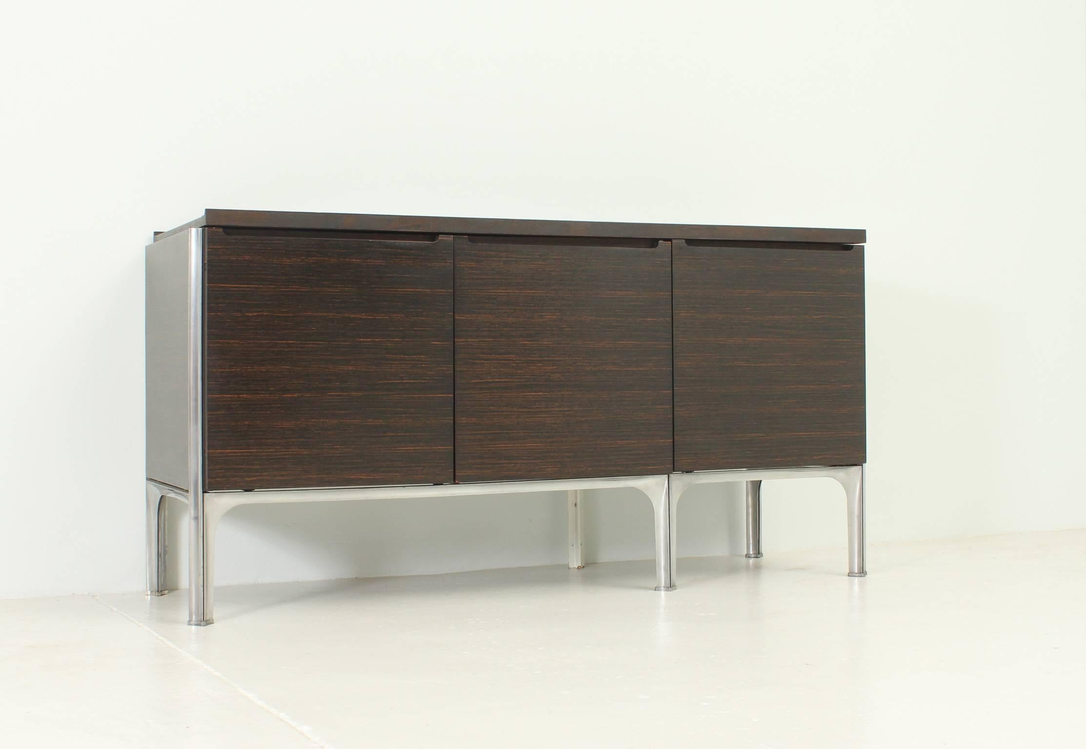 Rare sideboard designed in 1960's by Raymond Loewy and edited by DF 2000, France. Macassar ebony wood, lacquered wood and steel structure. Three spaces with one drawer and removable tray for bottles.