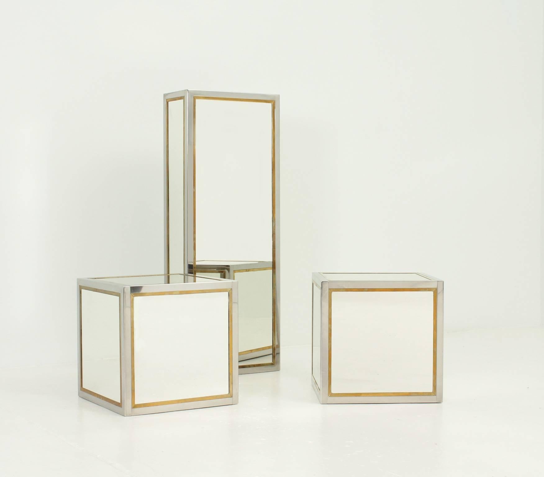 A set of three mirrored cubes used as pedestals or tables from 1970s in the manner of Romeo Rega, Italy. Mirror, chrome metal and brass frame.