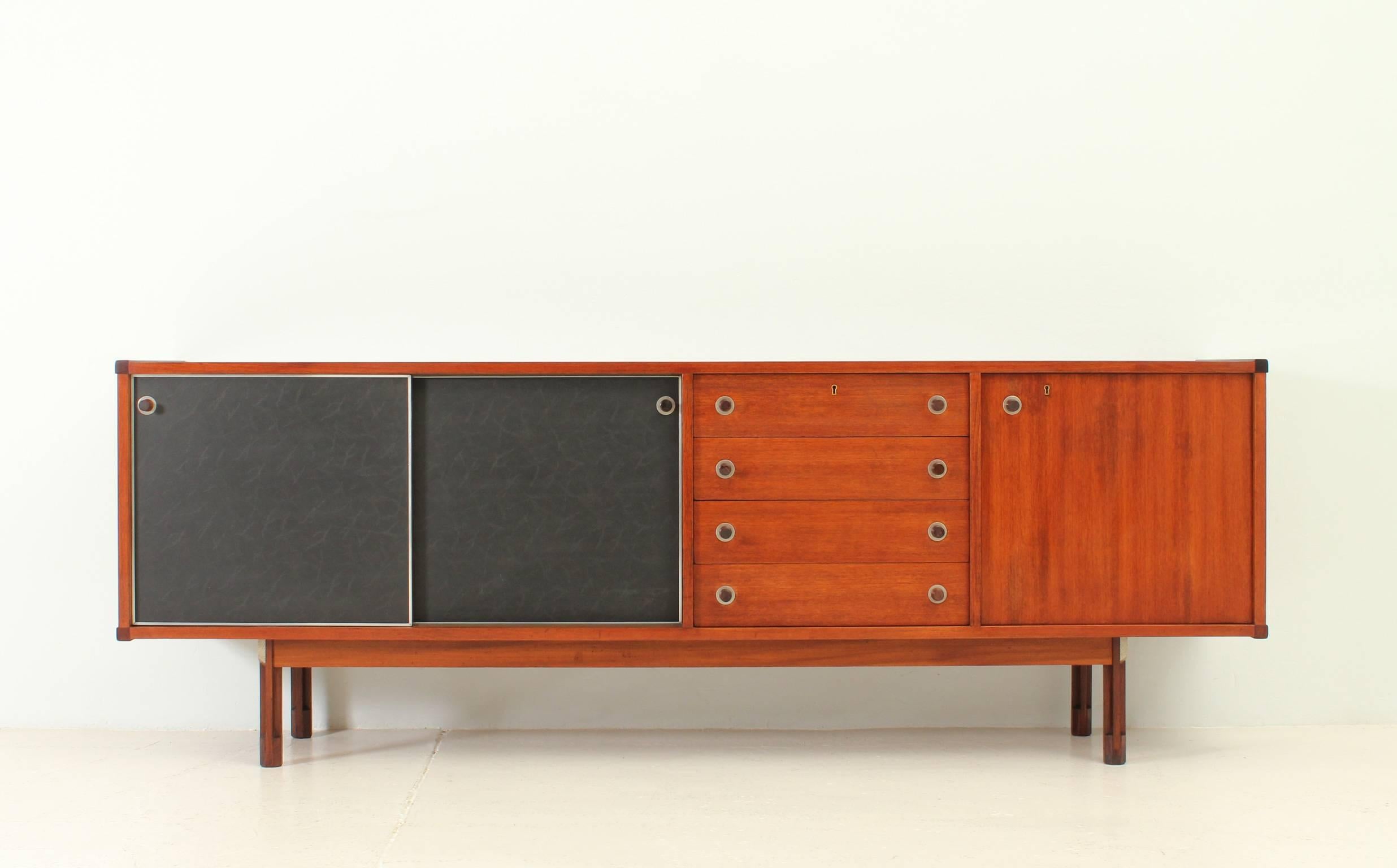 Italian sideboard from 1960s. Teakwood with rosewood details, two sliding doors with black leathered front and four drawers.