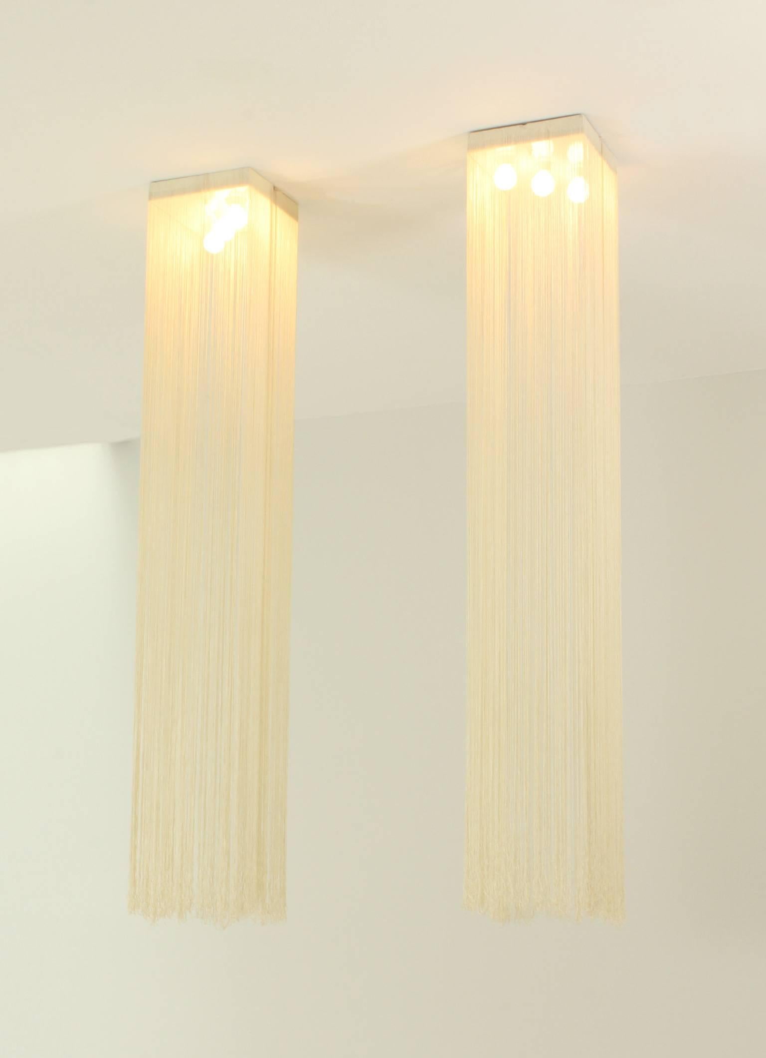A pair of Garbo ceiling lamps designed in 1976 by Mariyo Yagi and Studio Simon for Sirrah, Italy. Metal lacquered structure with three bulbs that supports a curtain of nylon fabric rope.