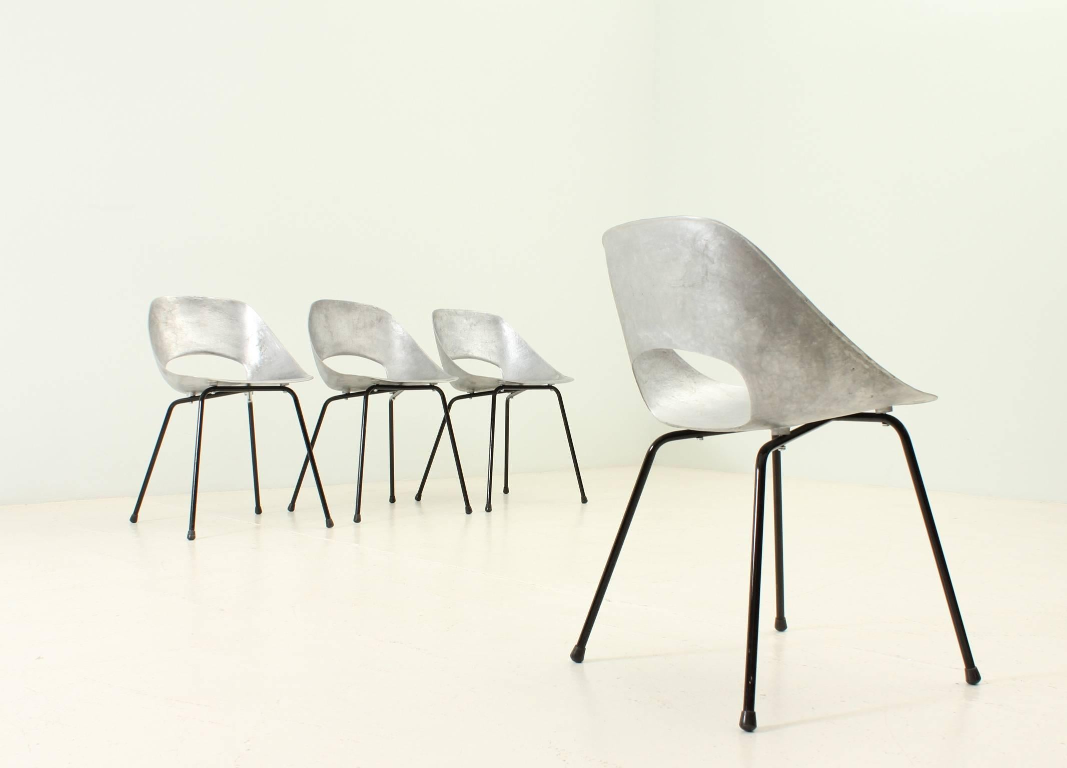 A set of four Tulip chairs designed by Pierre Guariche in 1954 for Steiner, France. Cast aluminium shell and lacquered metal base.