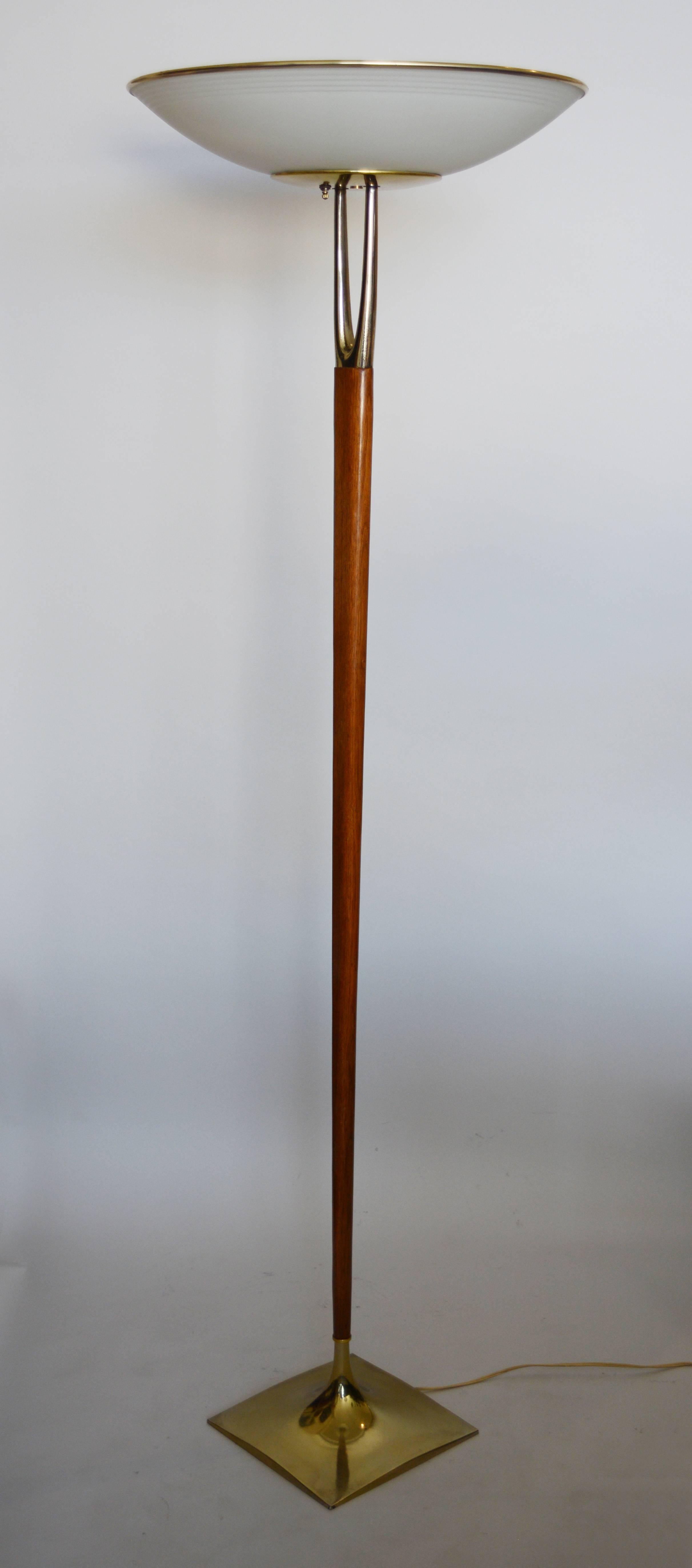 Modernist torchiere by Laurel. This has a walnut shaft with sculptural brass details at the base and top. The shade is frosted glass.