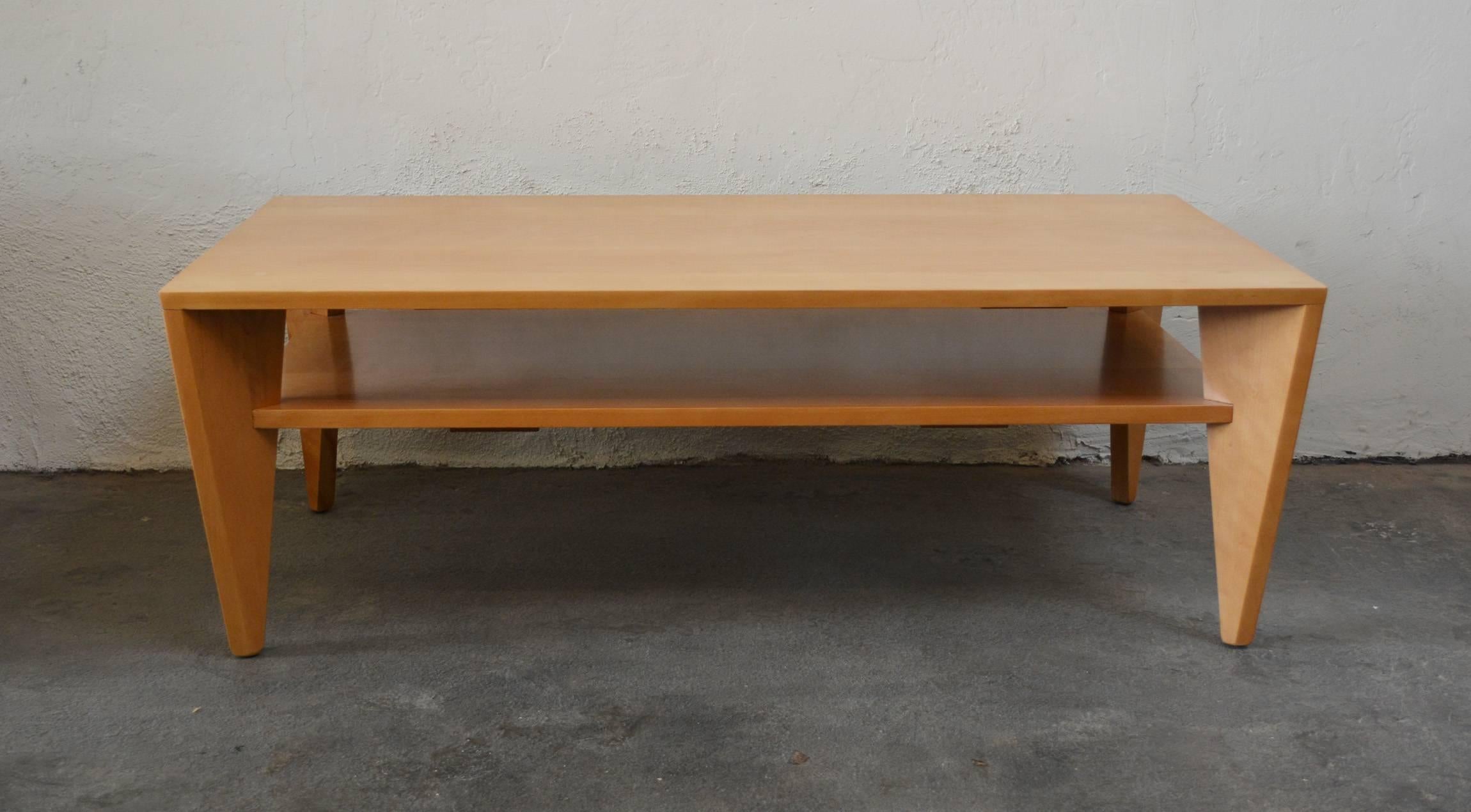 This angular solid birch coffee table was probably designed by Leslie Diamond for Conant Ball as part of the Modernmates line. This has been refinished.