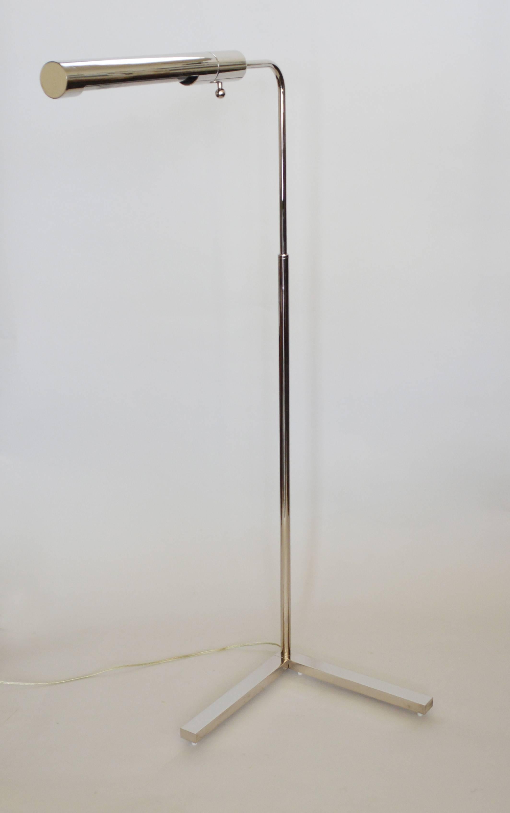 This high quality reading lamp is finished in a polished nickel plate. This has a dimmer switch. This lamp was probably made by Casella. The height is adjustable from 34