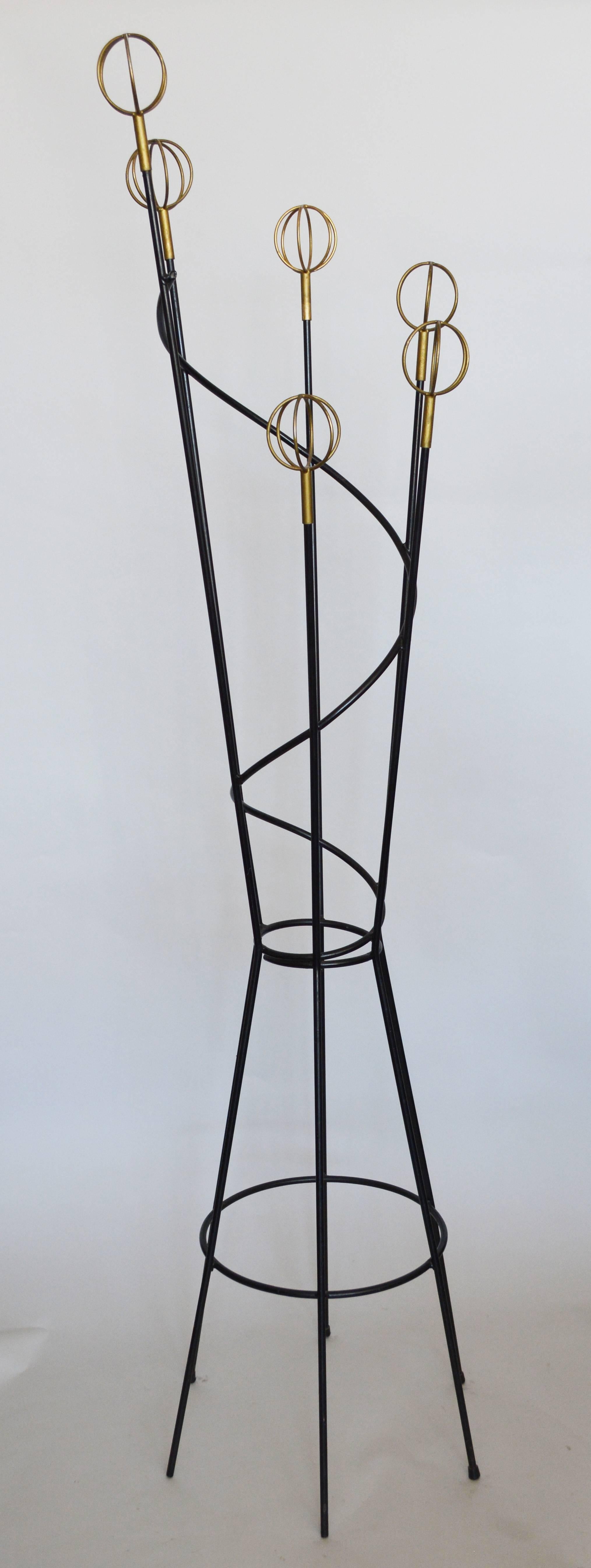 French modernist iron coat rack designed by Roger Feraud for Geo. This rack is iron with brass plate wire balls. The brass has been painted gold at some point in the past. It appears it was to cover rust on some areas. There are some losses of black
