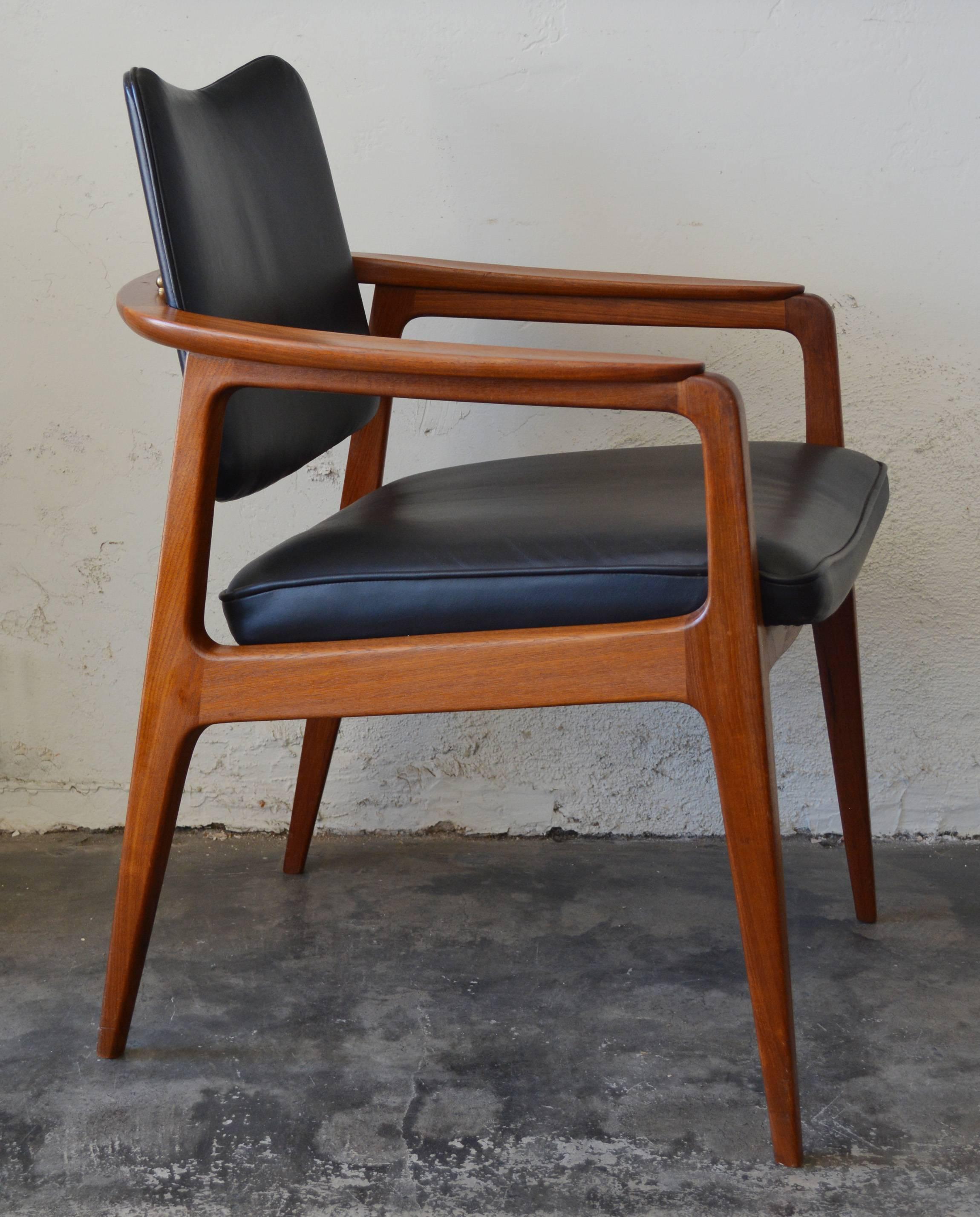 Mid-Century teak and leather armchair designed by Sigvard Bernadotte for France & Daverkosen and imported by John Stuart. This chair has a back that tilts. It is signed with the France & Daverkosen stamp and a John Stuart label.