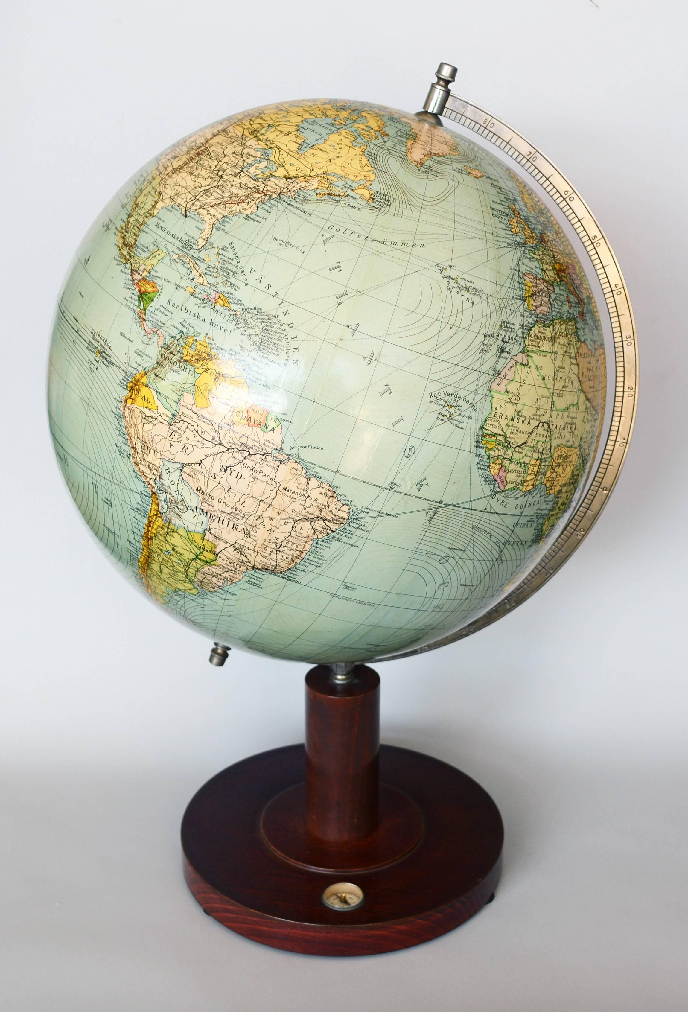 Vintage terrestrial globe by Columbus-Jordglob, Stockholm, Sweden. This globe shows French and Belgium territories in Africa. The wood base includes a small compass.