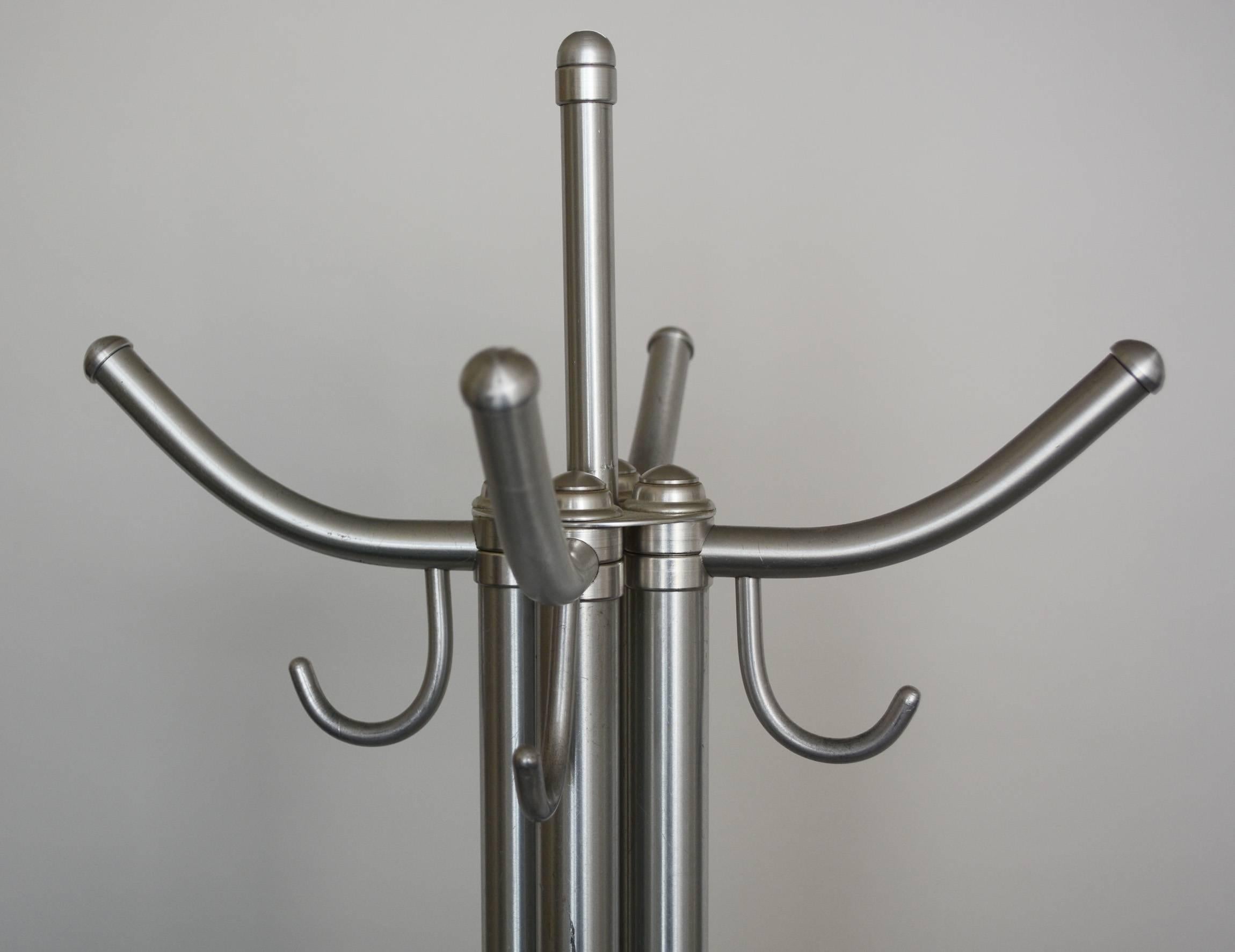Aluminum coat rack by Warren McArthur. This rack has a slight lean to one side, see the last photo. There is some spots of wear to the aluminum.