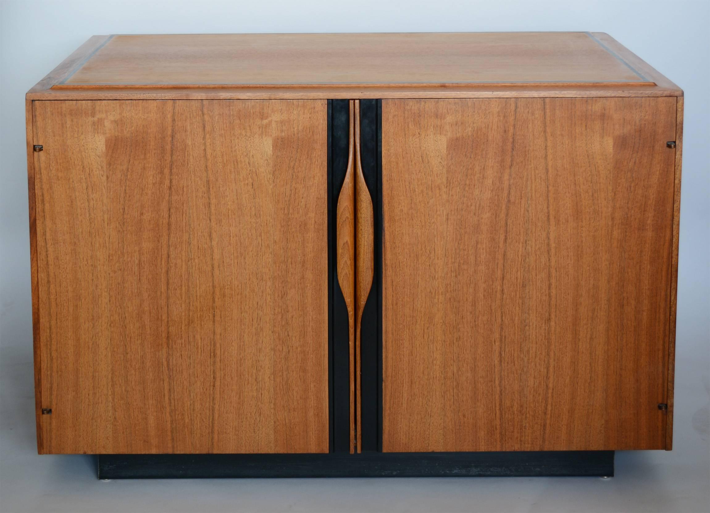 Versatile cabinet designed by John Kapel for Glenn of California. This can be used a small media cabinet or end table. This cabinet has sculpted walnut handles and a black plastic inlay detail on the top and along the handles. There is one